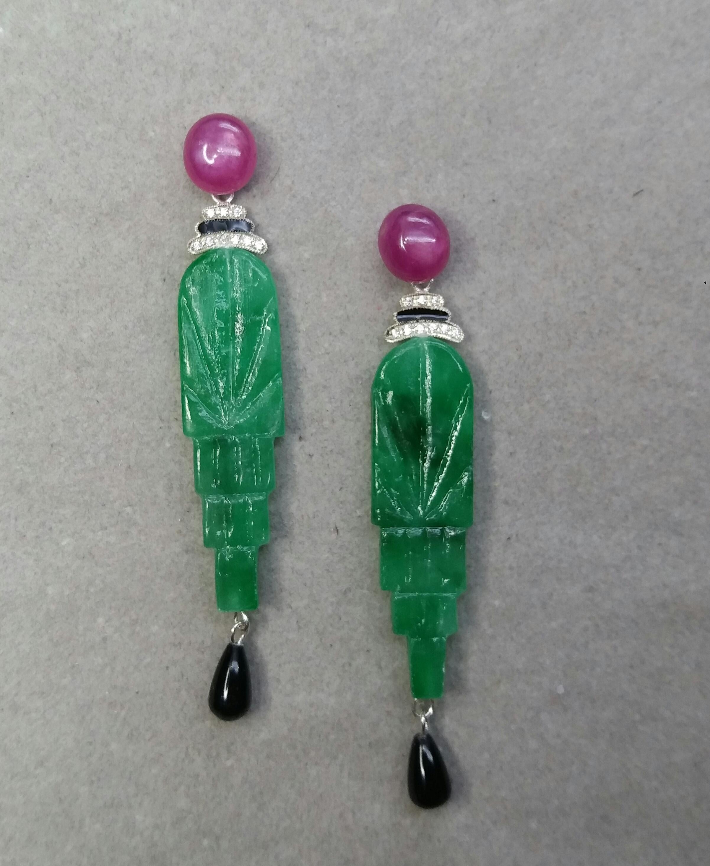 The tops are 2 Ruby Oval cabs ,middle parts are composed of 2 white gold elements with 14 round full cut diamonds and Black Enamel ,in the bottom parts we have 2 Engraved Jades 45 mm long and 12 mm wide to which are suspended 2 small black onyx
