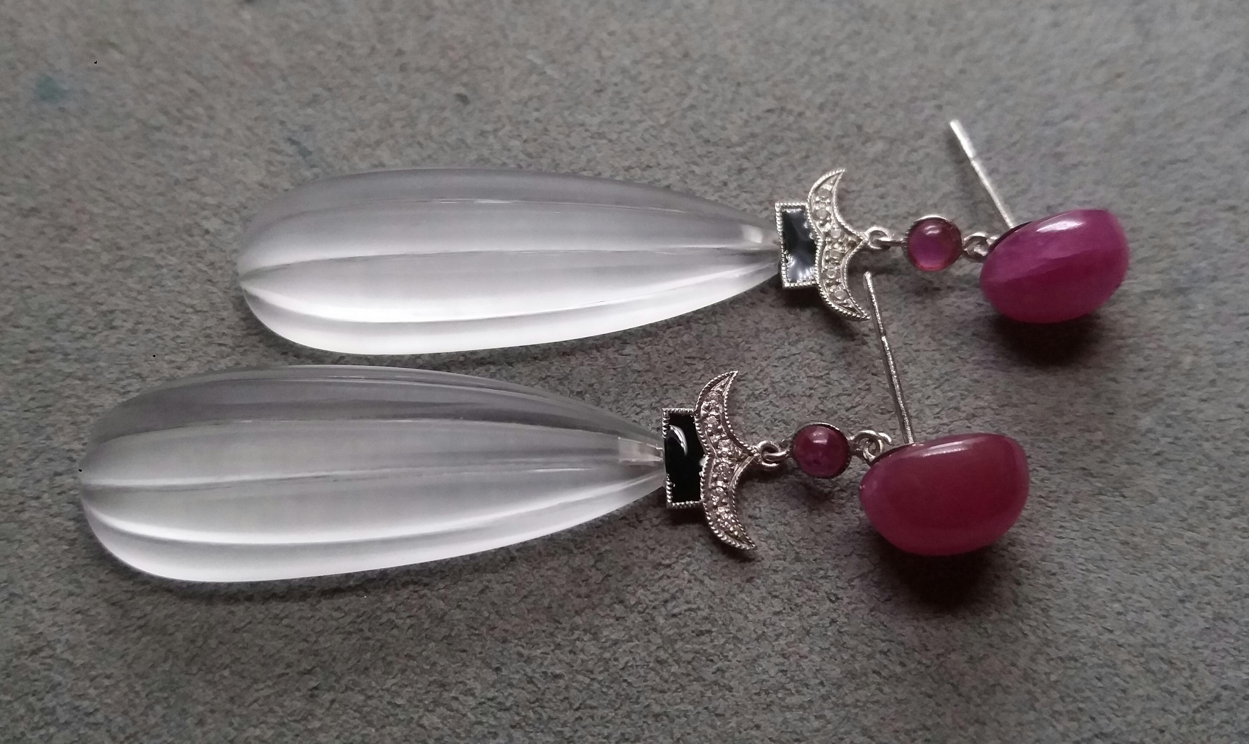 The tops are 2 Ruby Oval cabs ,middle  parts are composed of 2 small round Ruby cabochons and 2 white gold elements with 12 round full cut diamonds and Black Enamel ,in the bottom parts we have 2 Natural Rock Crystal Engraved Drops 35 mm long and 13