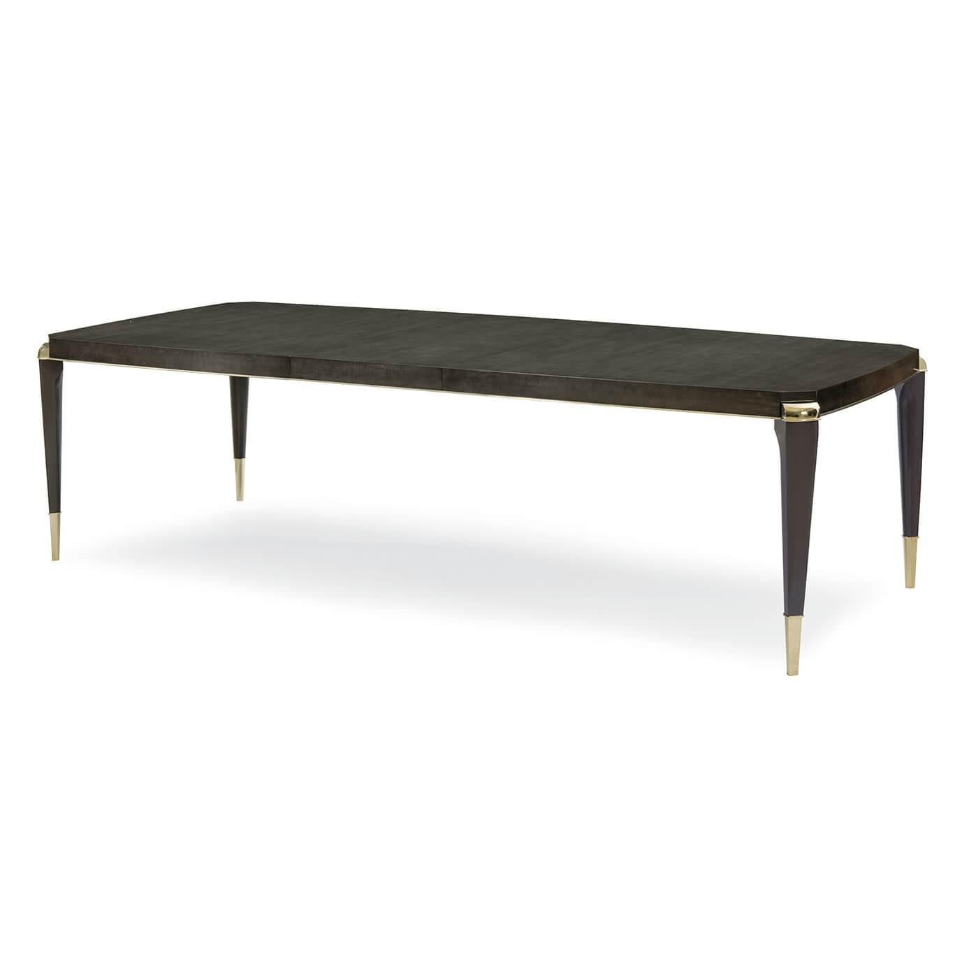 An Art Deco-style extension dining table that is perfect for intimate dinner parties or large family gatherings. This beautiful table is crafted with charcoal anegre. Its delicate finely figured wood compliments its bowed rectangular shape with