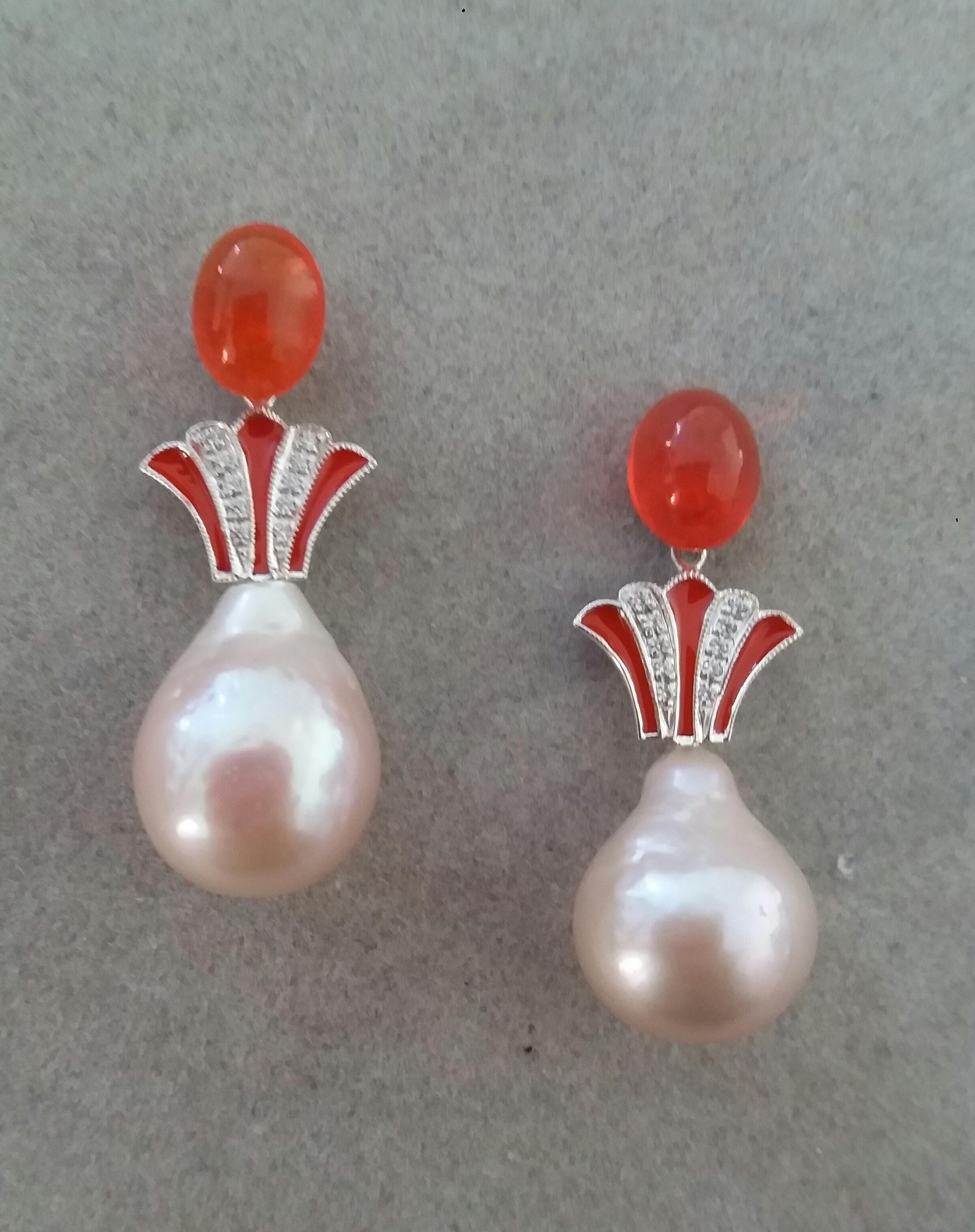 Unique pair of earrings with on top a pair of oval Fire Opal cabs ( 7 x 9 mm) ,a central part composed of  two  14 kt. White Gold elements in a Crown shape with 20 full cut round Diamonds and Orange Enamel. In the bottom parts we have 2 e Natural 