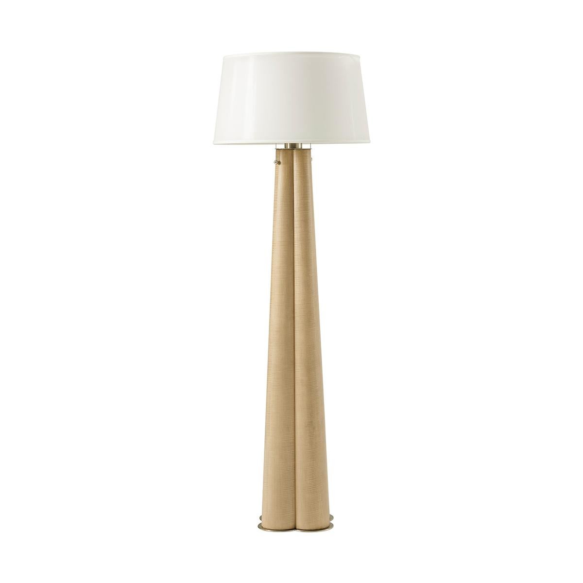 A beacon of 20th-century sophistication reimagined for the modern home. Inspired by the understated luxury of the 1920s, this floor lamp boasts a tapered cluster column form in a light sesame finish.

Whether it's enhancing a cozy corner or standing