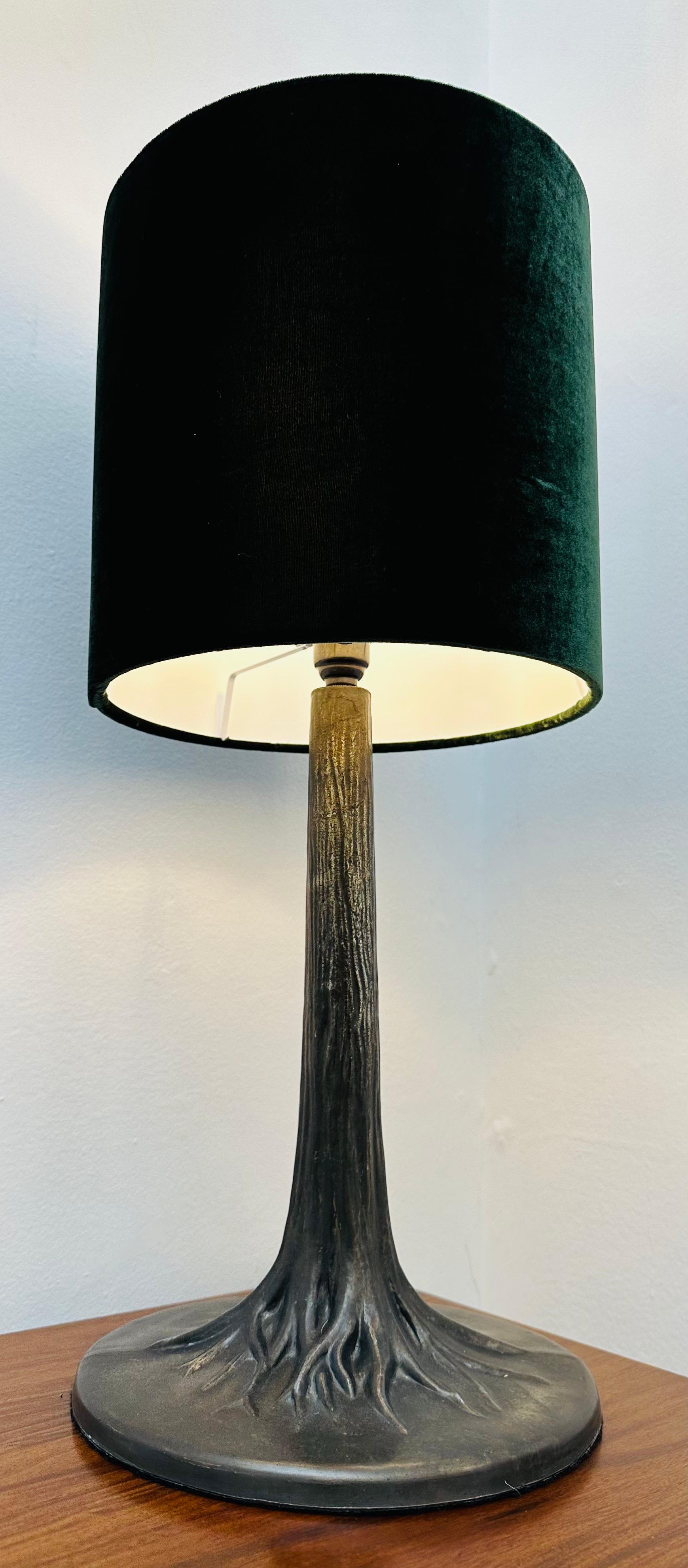 An unusual French Art Deco style antiqued metal tree trunk with roots effect which spread across the circular lamp base. Beautifully detailed and made with a felt base to protect whatever it's sat on from getting scratched.

An antiqued brass