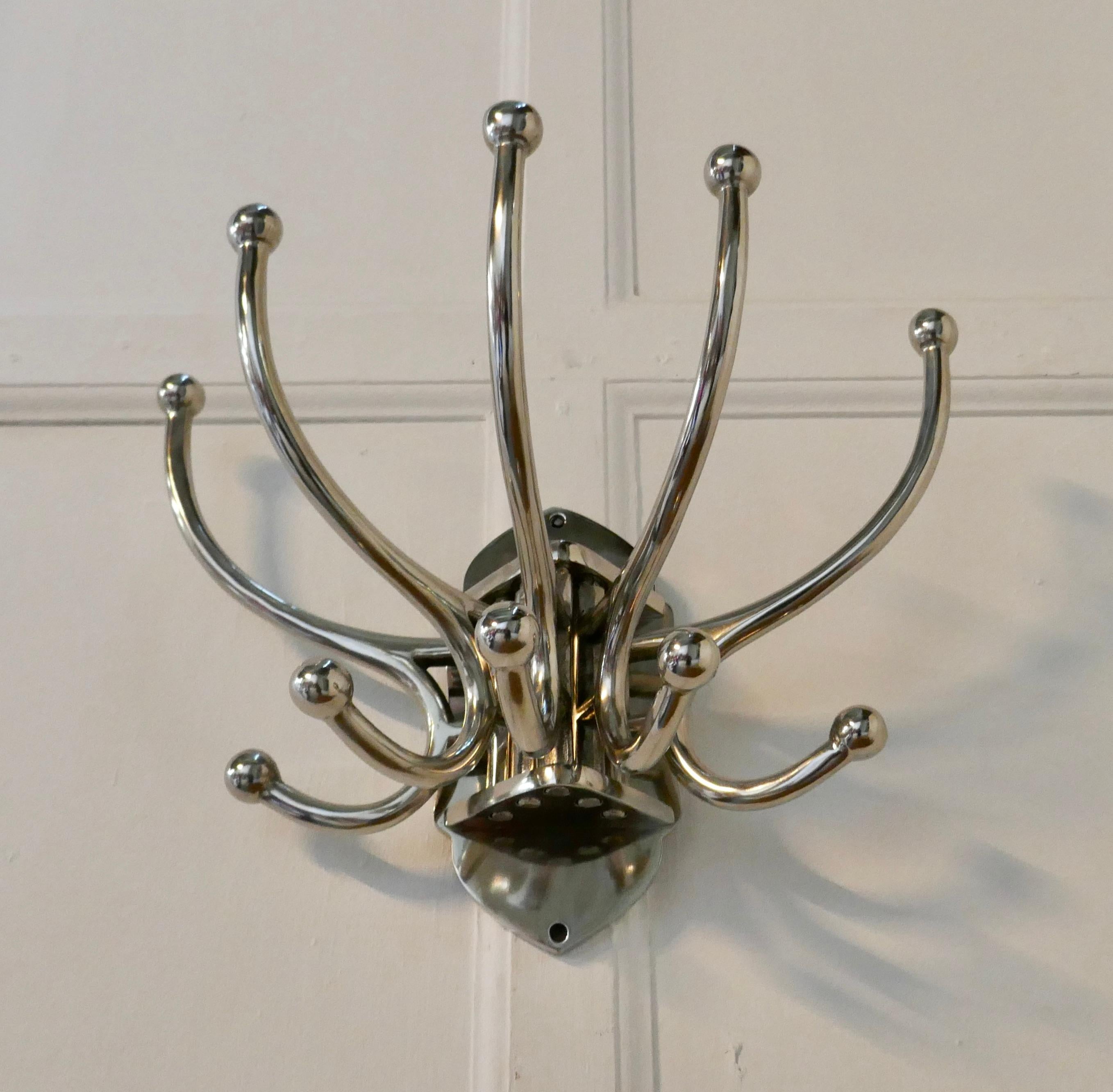 Art Deco Style French Chrome Coat Rack, Hat and Coat Hooks

Very Stylish Chrome Cloakroom Hanging bracket
The rack has 5 double swan neck hooks, these swing to the sides when required to fold flat
Strong and chunky a great idea
The bracket is