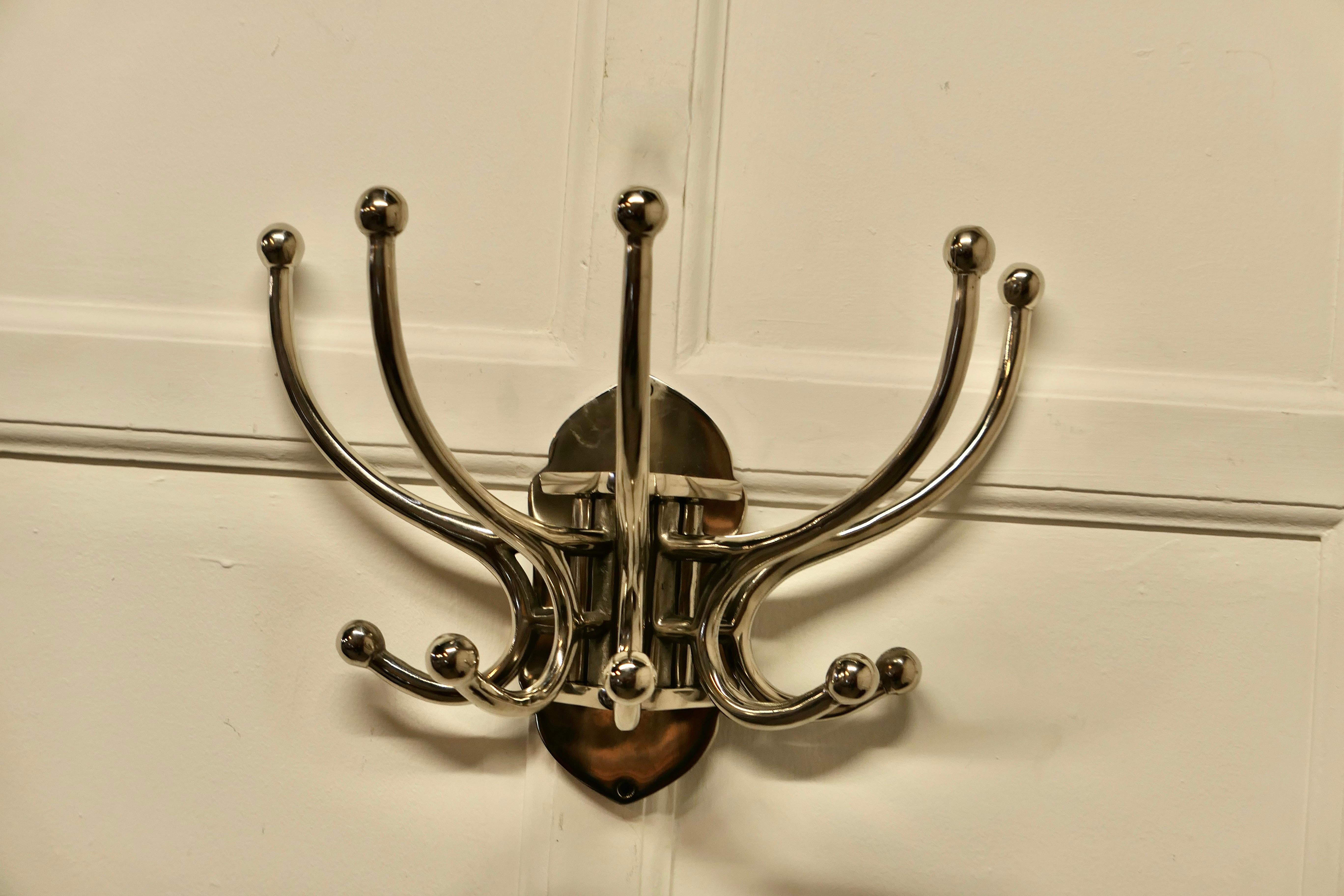 Art Deco style french chrome coat rack, hat and coat hooks

Very stylish chrome Cloakroom hanging bracket
The rack has 5 double swan neck hooks, these swing to the sides when required to fold flat
Strong and chunky a great idea
The bracket is