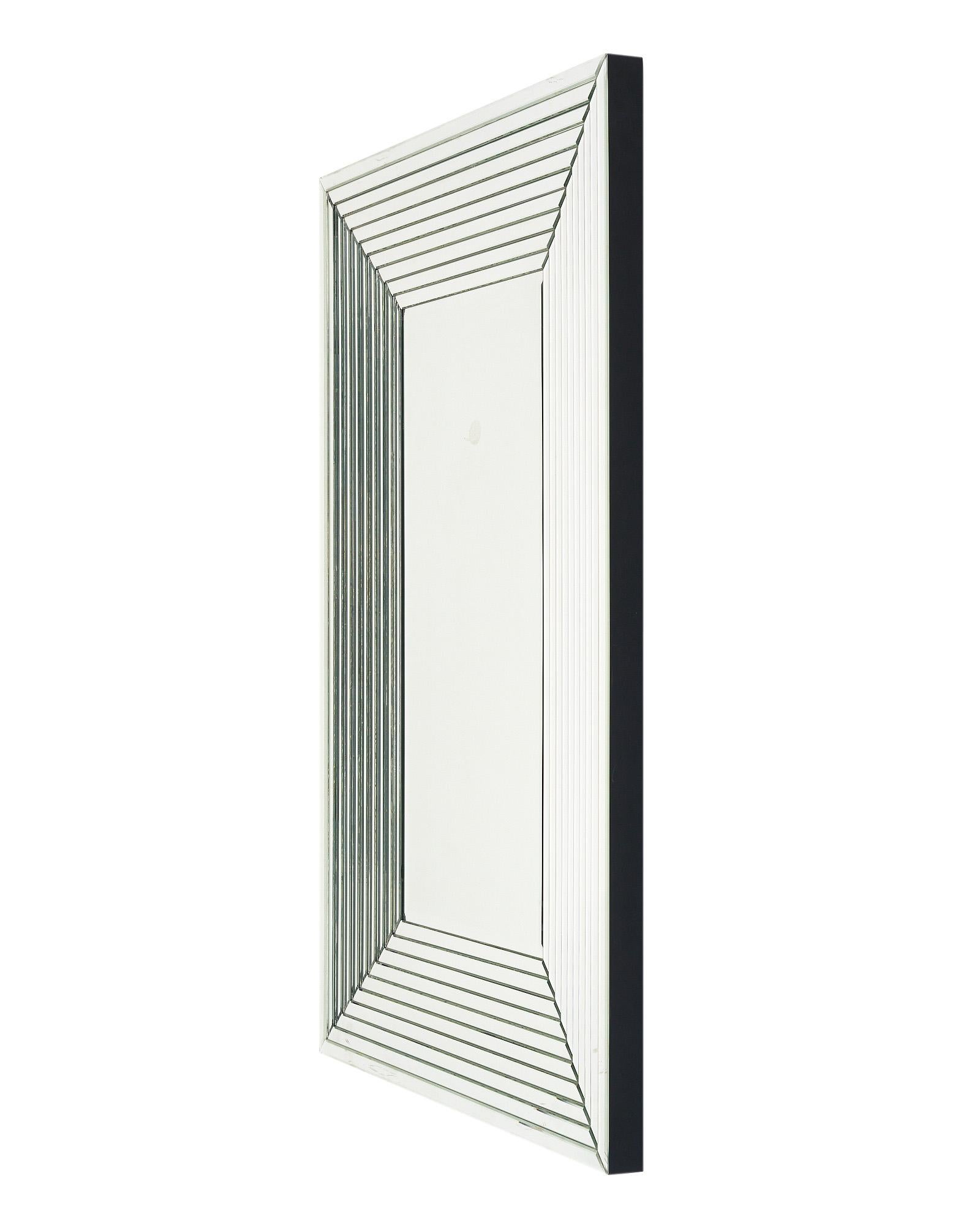 Large mirror from France in the Art Deco style. This piece has a wood structure with layered mirrors creating a Deco frame to the central beveled mirror. It can be hung vertically or horizontally and has a strong presence in any space.