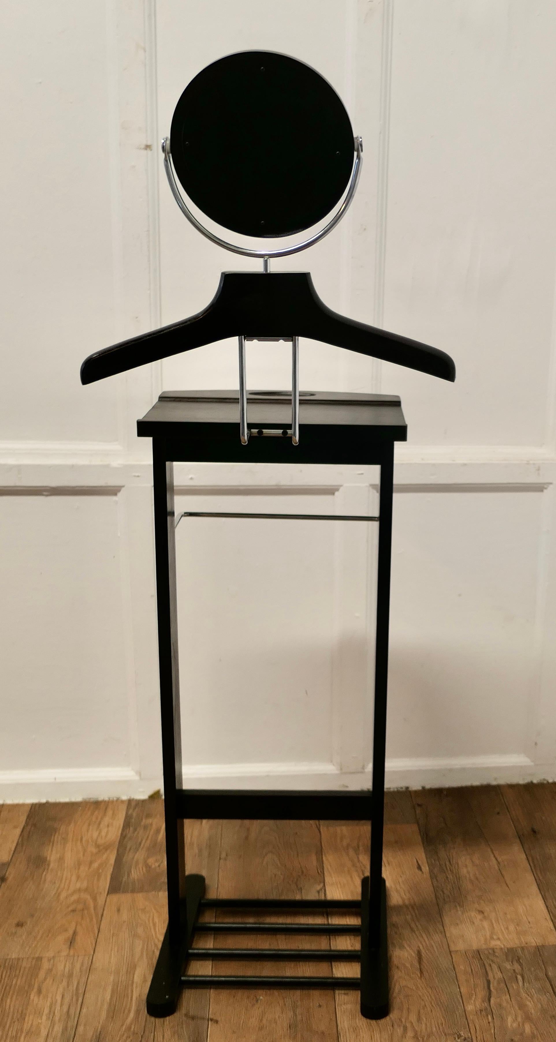 Art Deco Style Gentleman’s Suit Hanger or Night Stand, Bedroom Valet,

A very useful piece, the hanger or clothes stand is in Black Lacquer, it has a circular vanity mirror, a hanger which will accommodate a jacket it also has a separate rail for