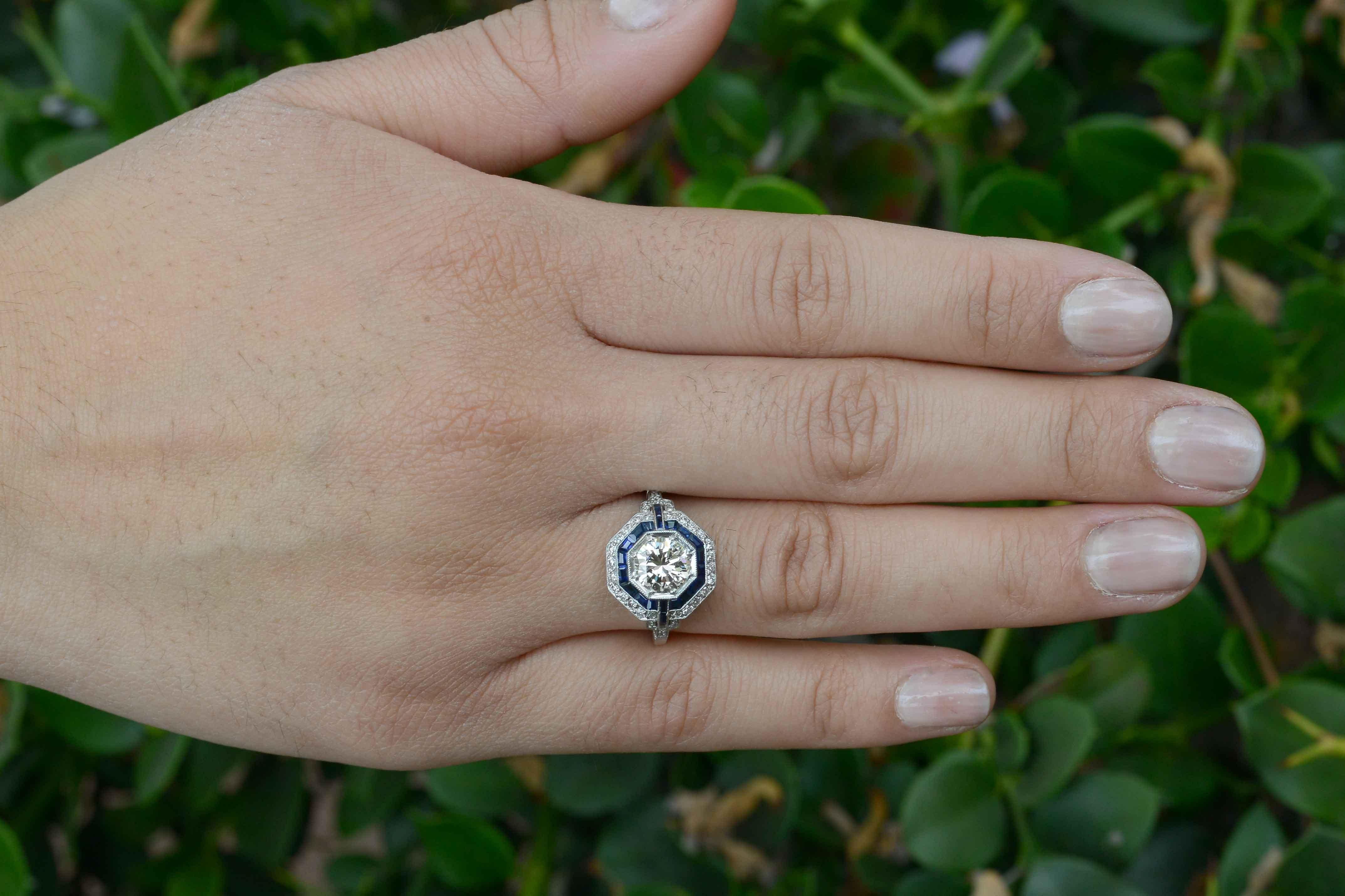 If you can keep your eyes off the dazzling, fiery 2 Carats of gems long enough, you'll notice one of the most amazingly detailed and seductive cocktail rings ever. An architectural composition of calibre' & French cut sapphires in an octagon halo