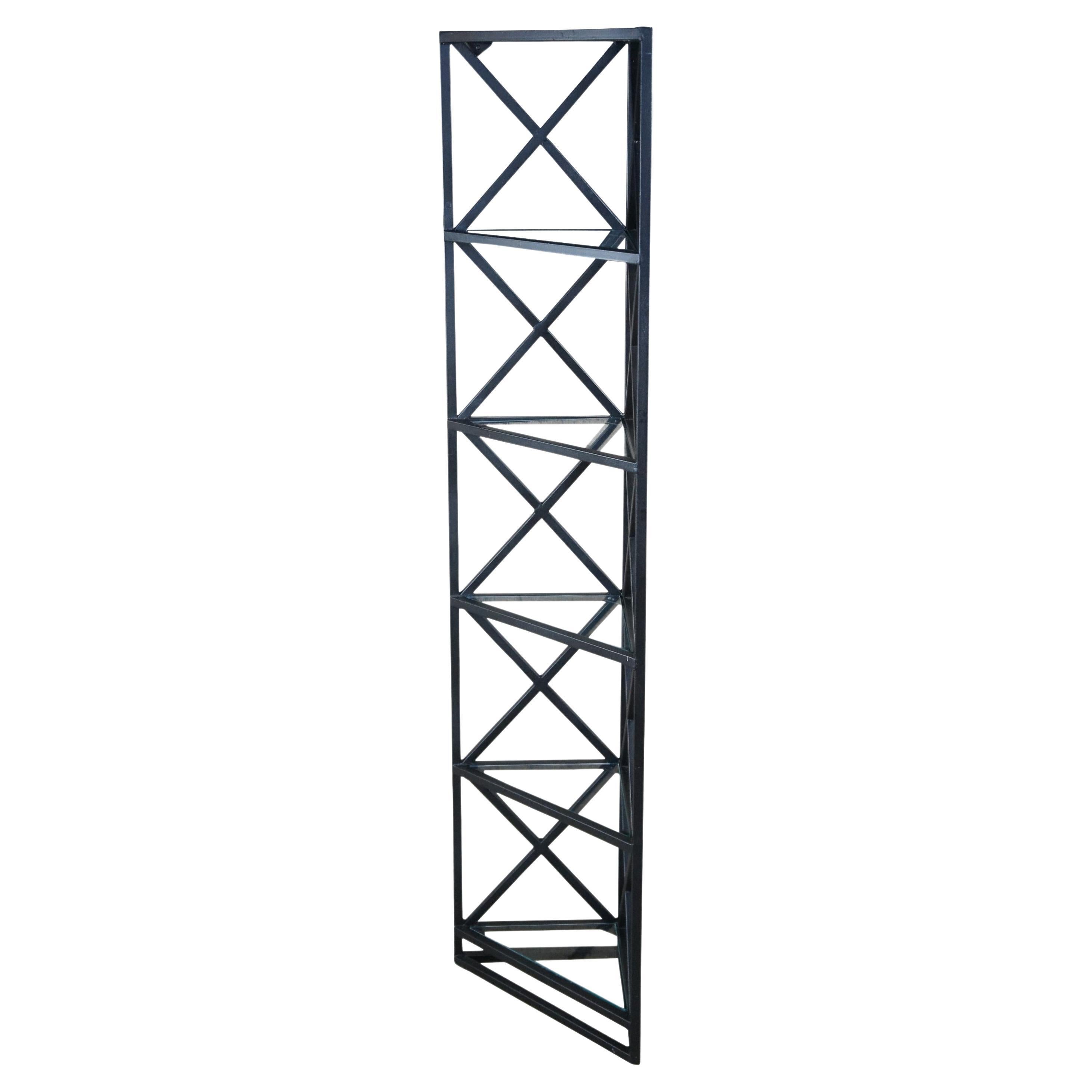 An art deco style triangular geometric corner shelf. Features tempered glass shelves. Brackets along the top allow it to be mounted to the wall. Measures: 63