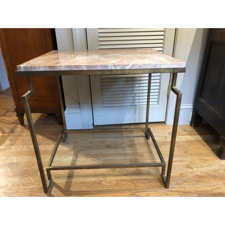 Art Deco style gilt metal “Apollo” occasional table. Excellent proportions, very architectural with a “distressed” gilt finish to the metal. This table with a fossilized limestone top is custom designed and fabricated by Hastening Designs. Perfect