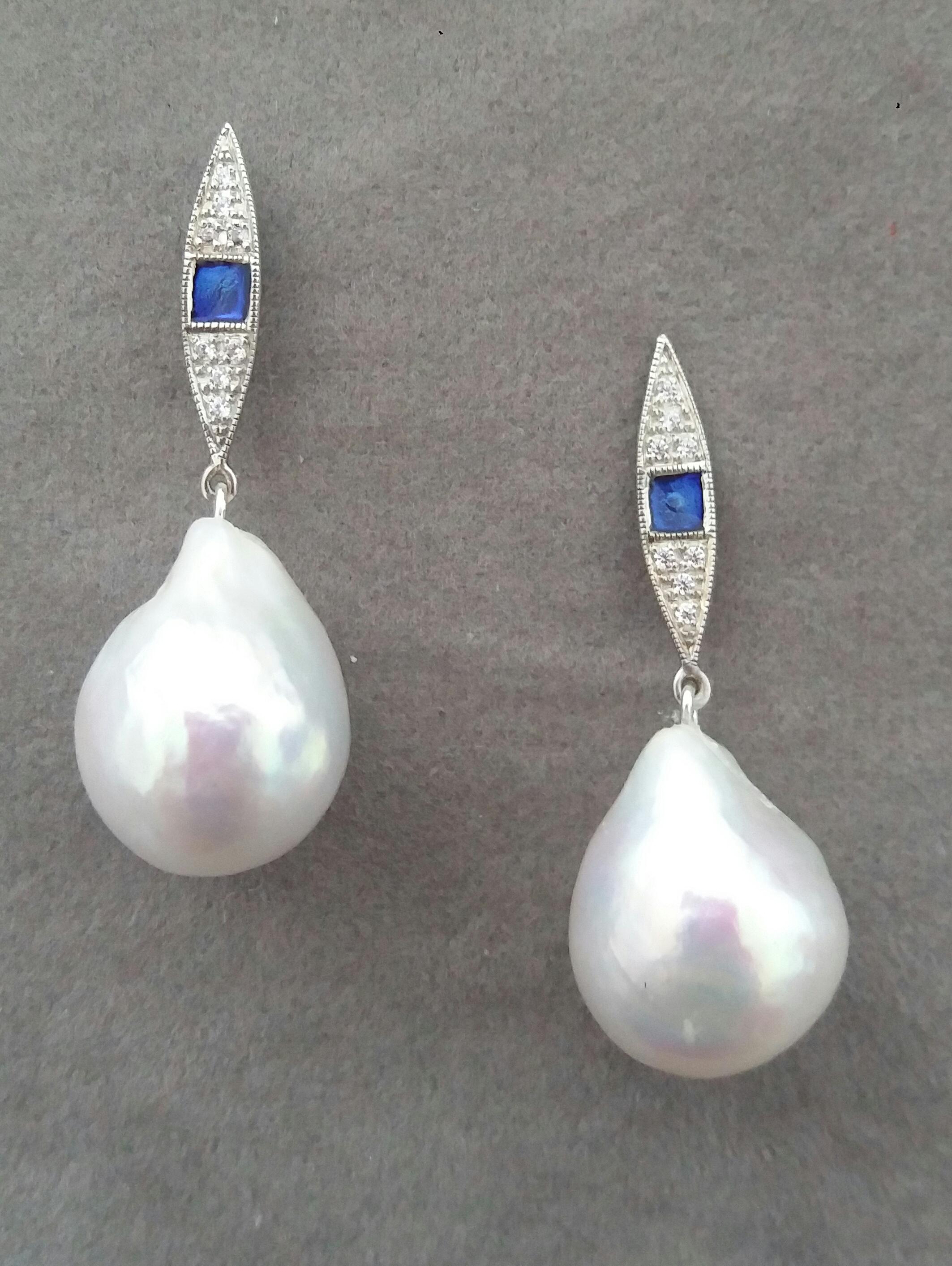 Unique pair of  earrings with on top 2 white gold elements  in a marquise shape with 16 full cut round Diamonds and Blue Enamel. In the bottom parts we have 2 White  Color Pear Shape Baroque Pearls measuring 14x 18 mm. and weighing 41 carats.

In