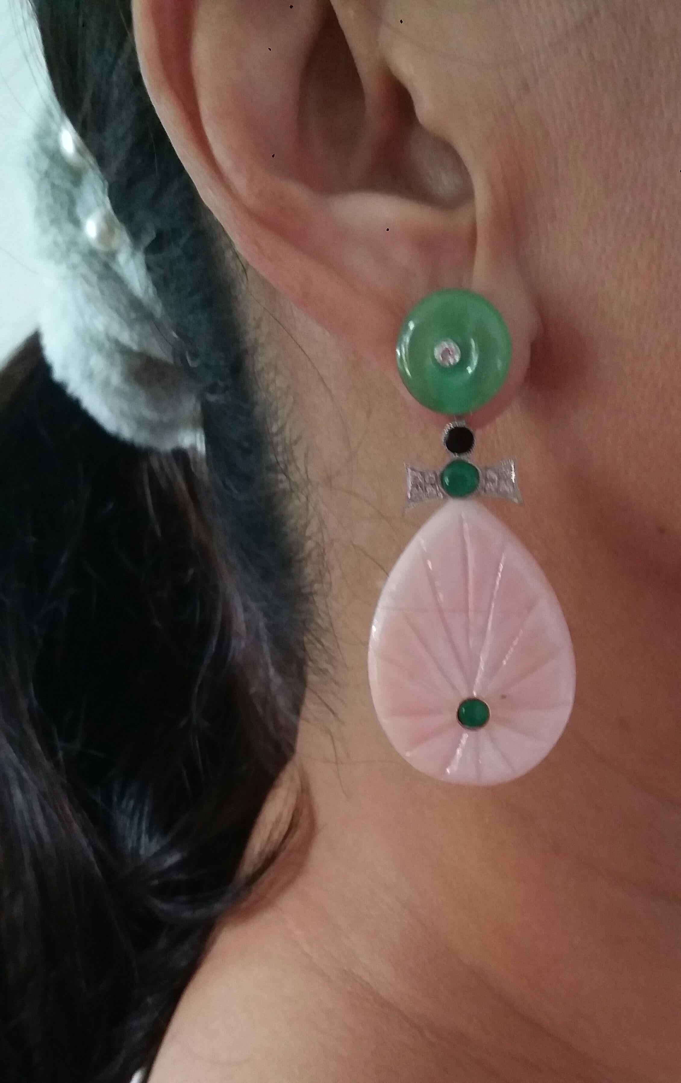 In these classic Art Deco Style earrings we have the tops with 2 Jade discs with small diamonds set in gold in the center ,the middle parts are composed of  2 elements in White Gold, Diamonds small round Emerald cabs and Black Enamel,while in the