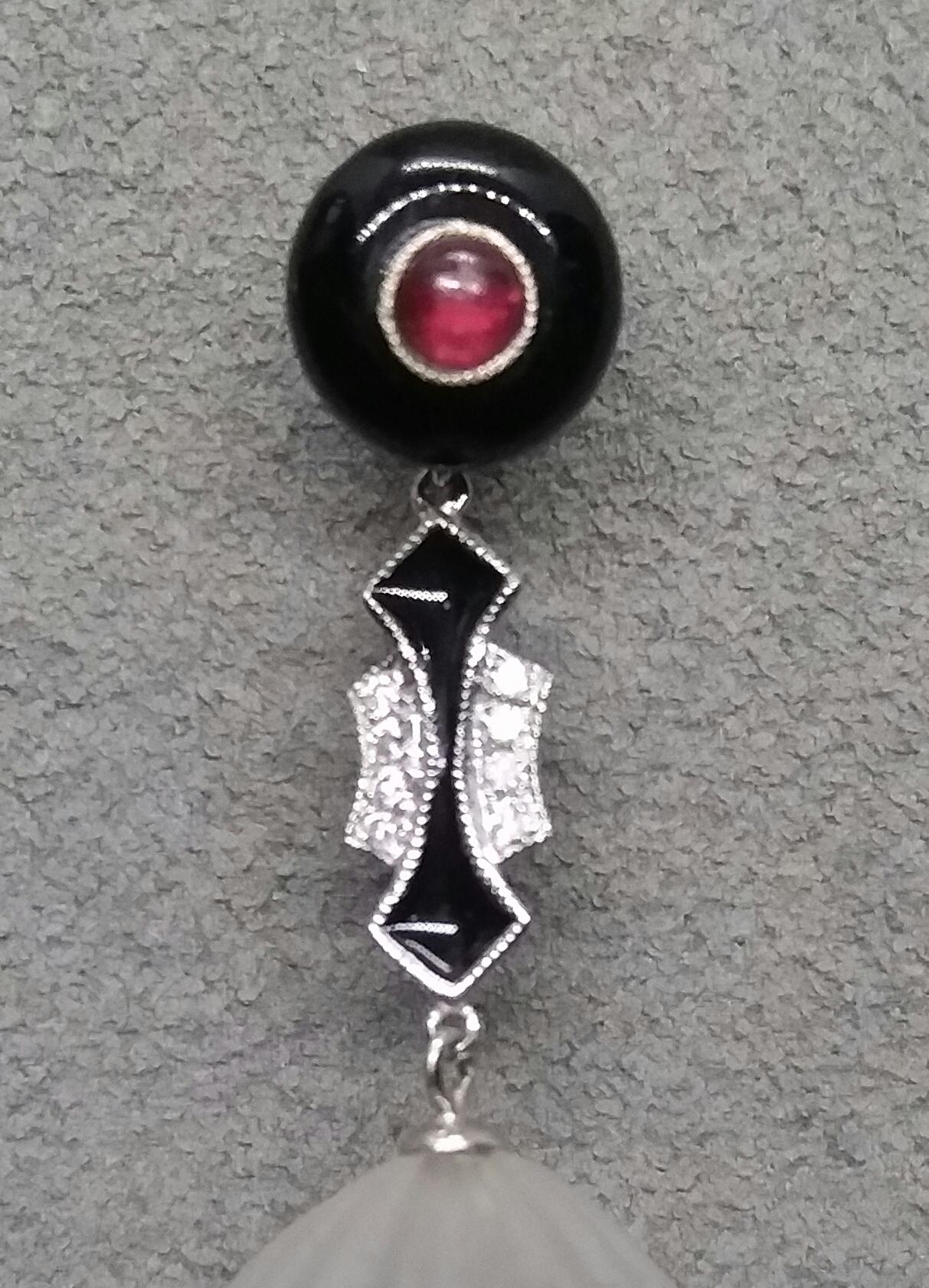 In these classic and totally handmade Art Deco Style Earrings the tops are 2 round black onix of 10 mm in diameter with small ruby round cabochons in the center,middle part in white gold,small full cut diamonds and black enamel,the bottom parts are