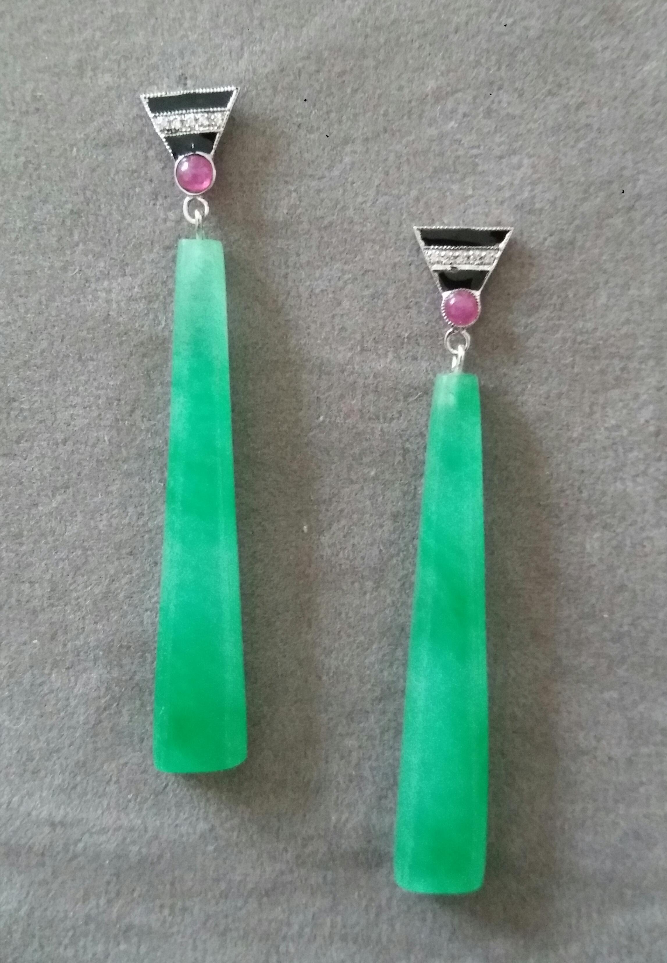 In these classic and very light Art Deco Style earrings the tops are 2 parts  in 14 kt.white gold, 8 round full cut diamonds,small round ruby cabs and black enamel ,in the lower parts we have 2 Plain Burma Jade parts in trapeze shape  measuring 