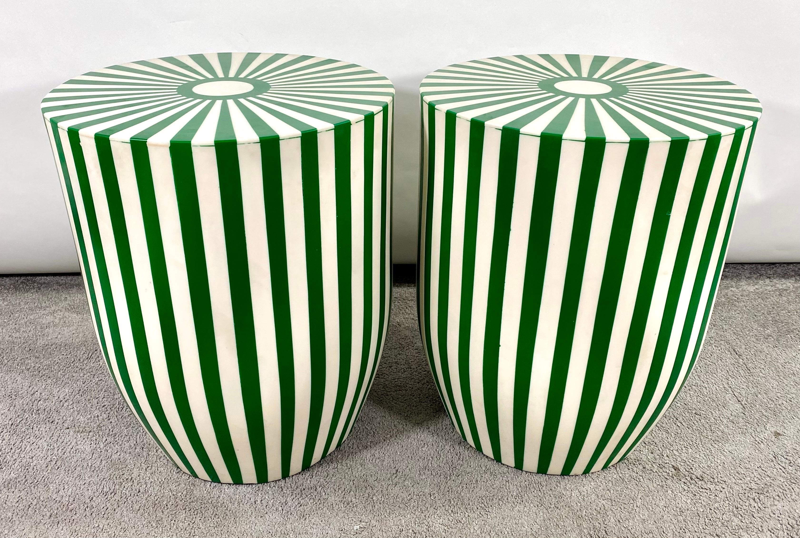 An exquisite pair of Art Deco style green and white side tables or stools featuring a striped design. The tables are made of quality resin and have a solid and sturdy structure. The sculptural cylindrical shaped tables or stools have a round top and