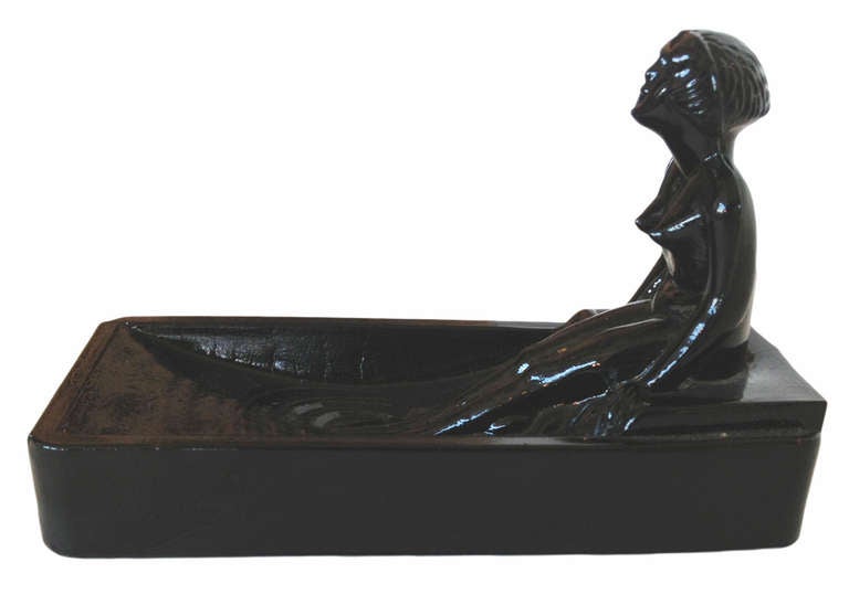 This 1970s re-edition of a 1927 Art Deco Heinrich Hoffman black onyx art glass soap dish / ring tray features a nude female figure bathing in a tub.

Condition: Excellent.
Specifications: Height 2.75, width 6, depth 4.
Materials /techniques: