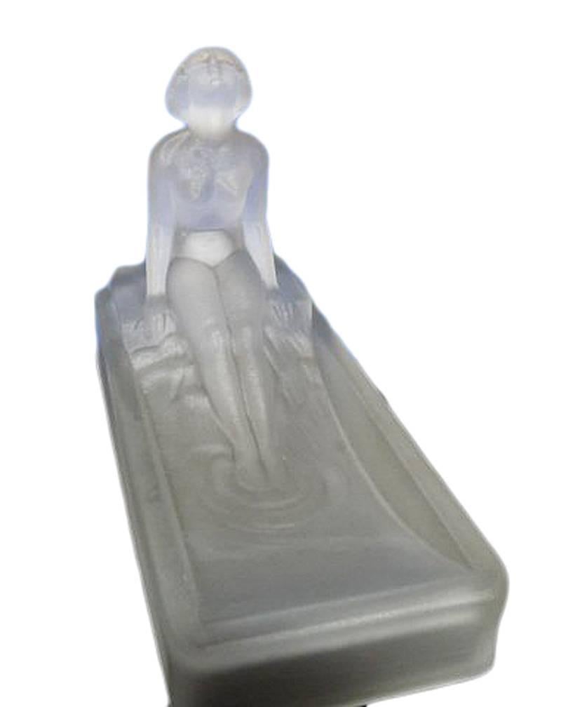 This 1970s re-edition of a 1927 Art Deco Heinrich Hoffman frosted green art glass soap dish or ring tray features a nude female figure bathing in a tub.

Condition: Excellent.
Specifications: Height 2.75, width 6, depth 4.
Materials or