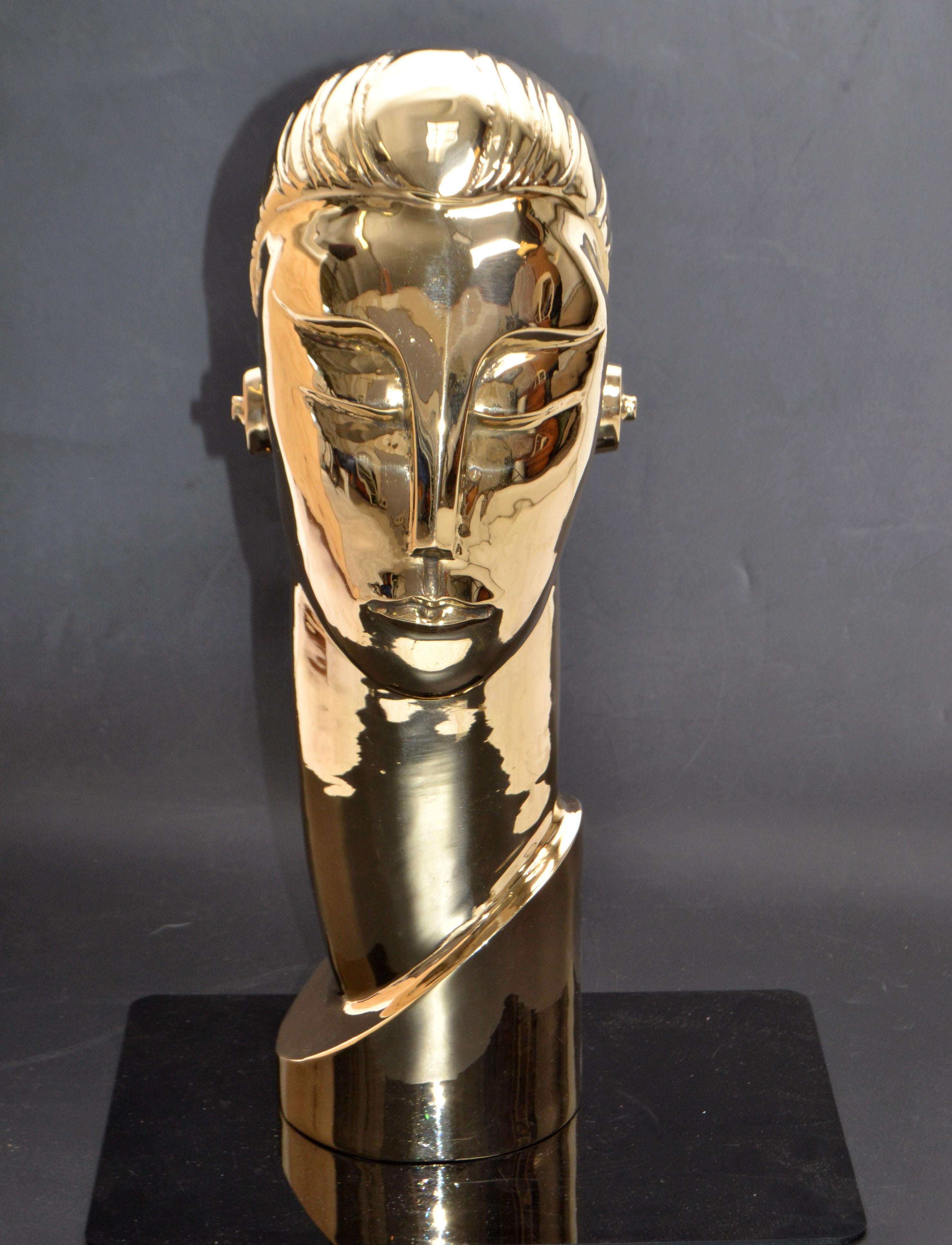 Art Deco style manner of Franz Hagenauer bronze bust with elongated neck.
Figurative sculpture depicting the head of a figure with elongated neck and pegged ear adornments.
No signature found. Made circa 1965-1969.
 