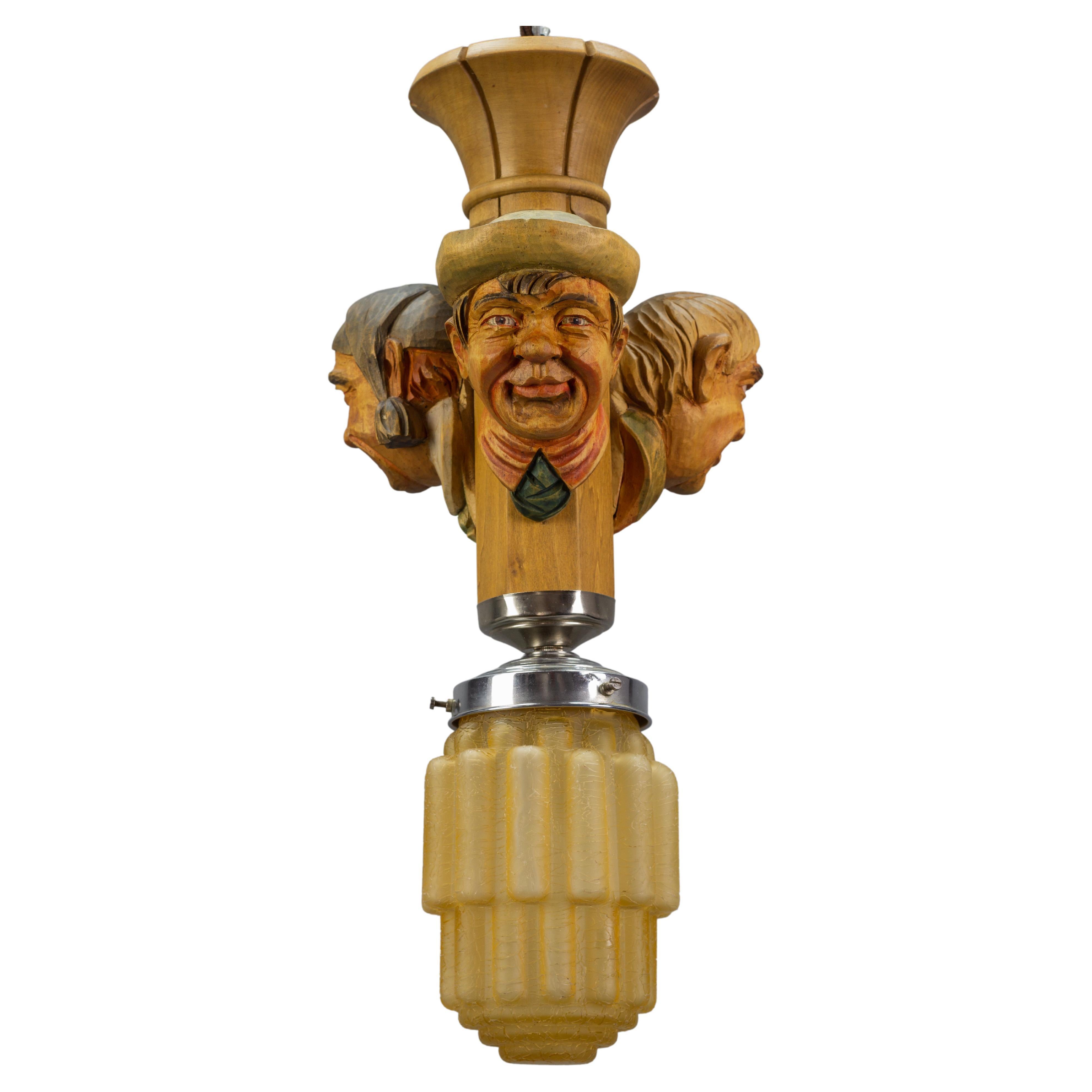 Art Deco Style Hand-Carved Wooden and Crackle Glass Pendant Light Three Men  For Sale