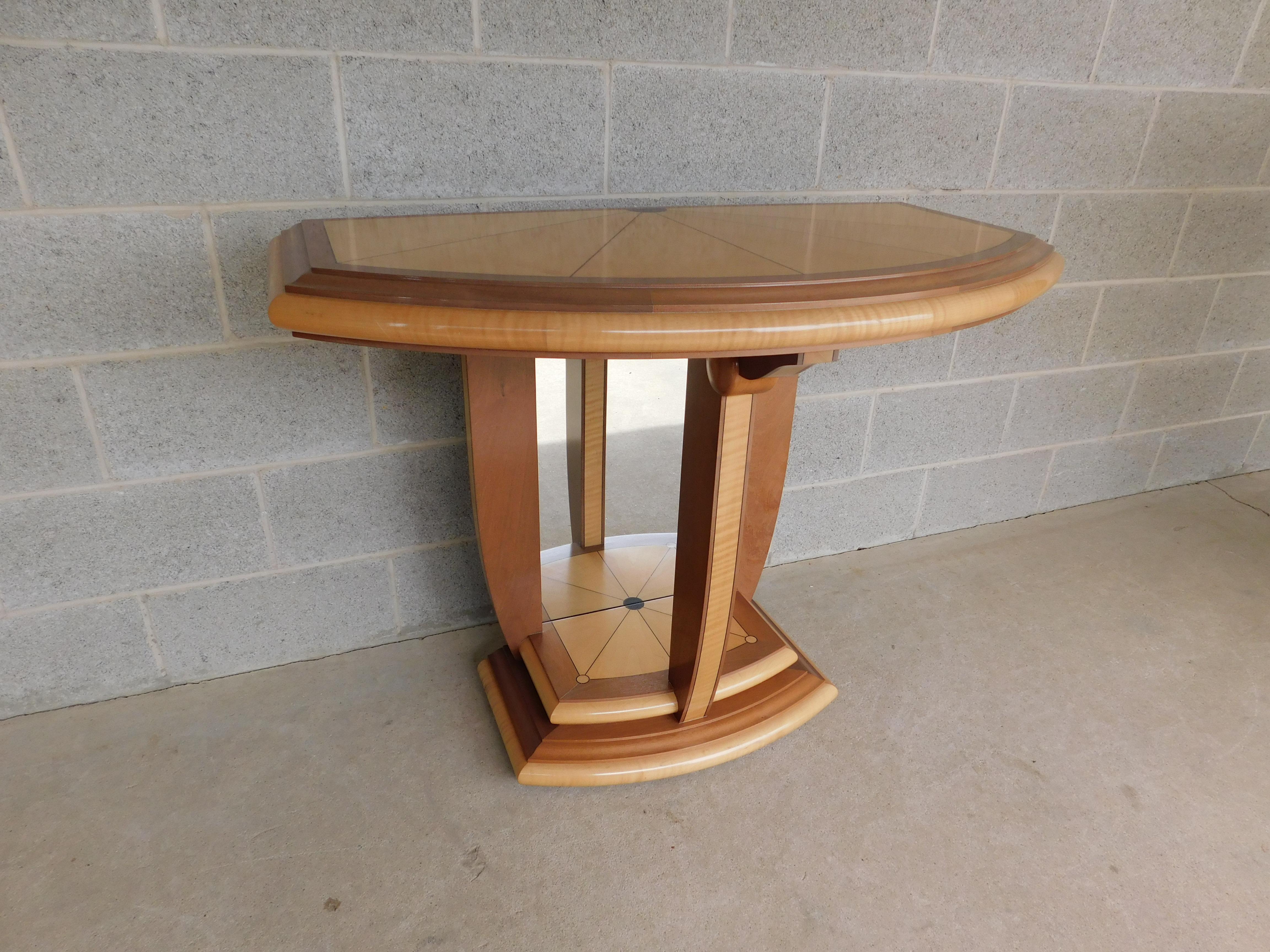 Features quality solid hand made construction - inlay details, custom finish, Art Deco-inspired design. Beautifully constructed of figured maple & exotic hardwoods the Demi style table raised on open columned mirrored backed standard and stepped