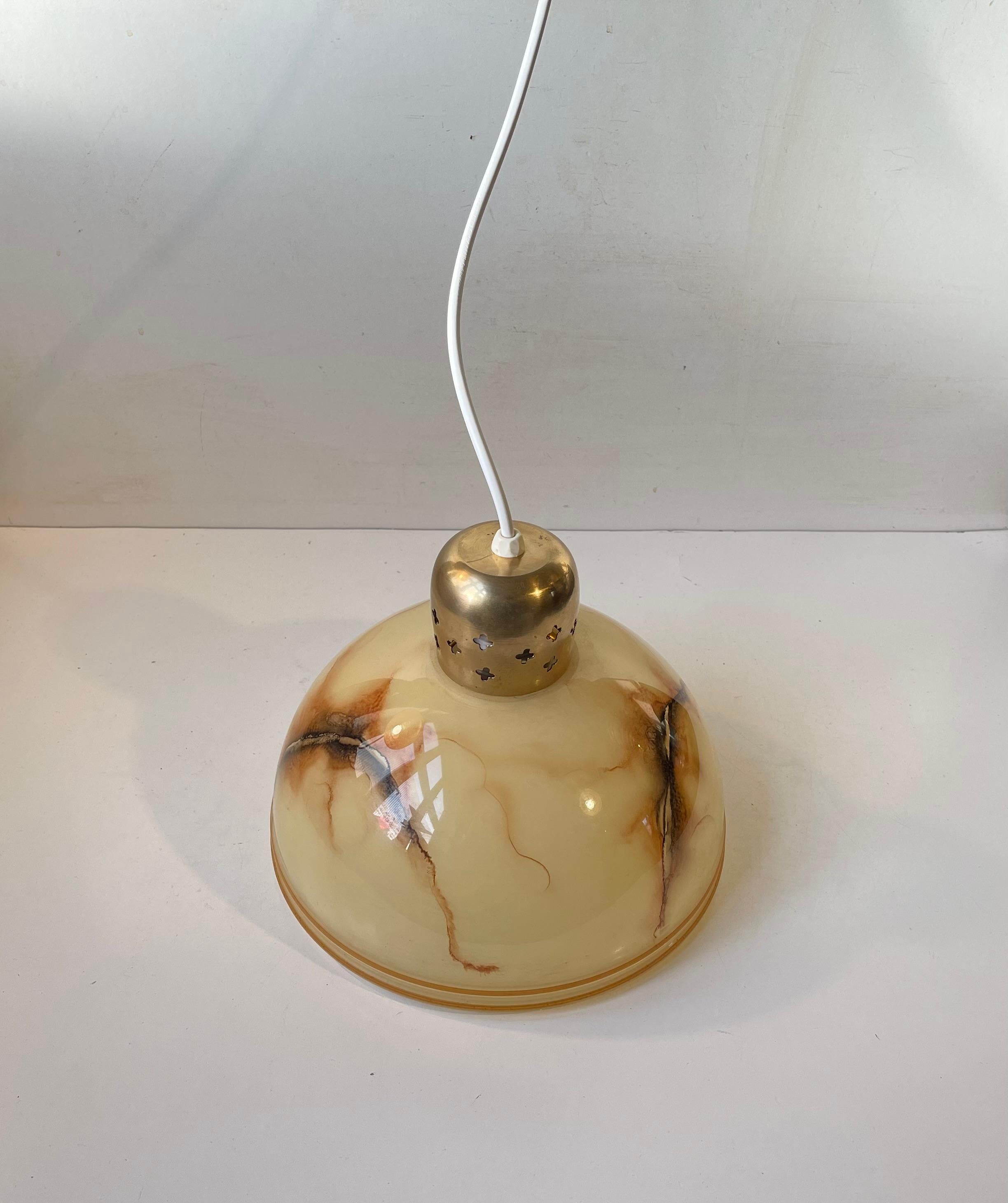 Danish art deco/functionalist pendant light partially perforated solid brass and marbled glass. It was manufactured in Denmark during the mid-late 140s. New and secure wire and fitting has been installed. Measurements: H: 20 cm, Diameter: 23 cm.