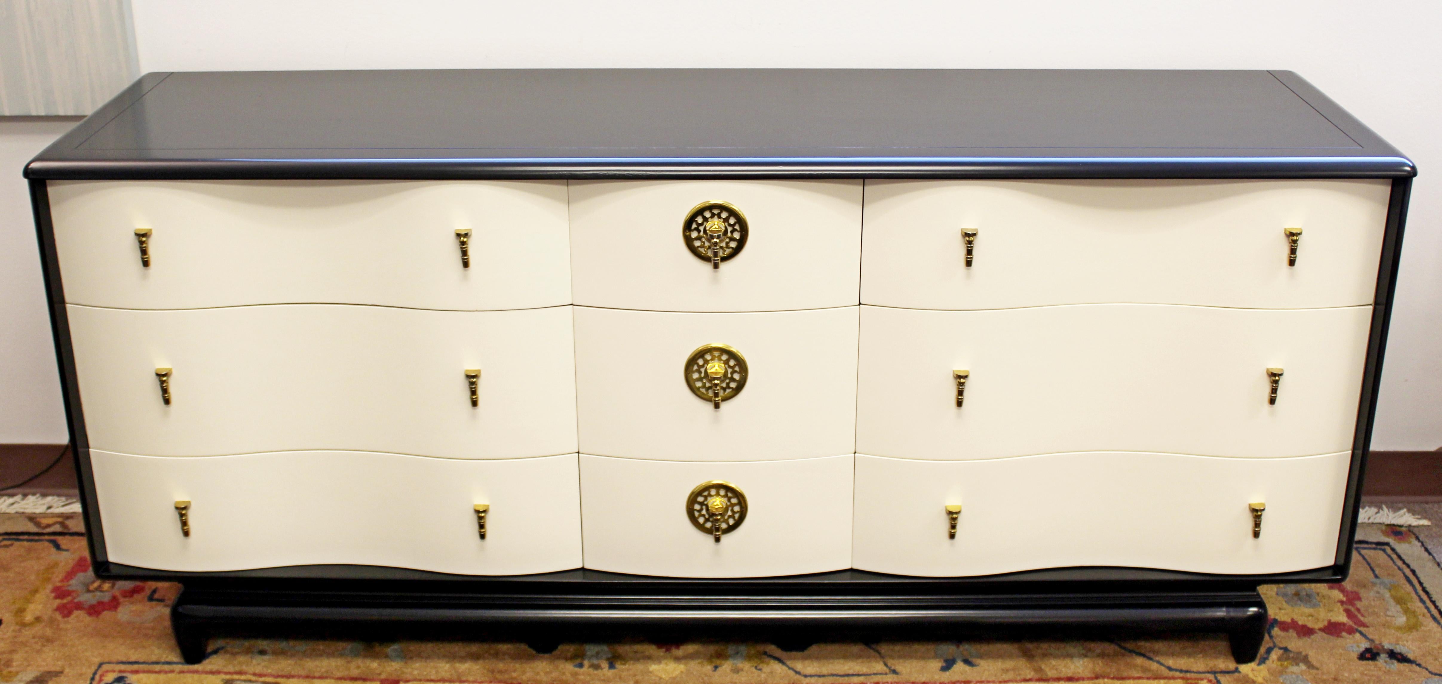 For your consideration is a drop dead gorgeous, black and white lacquered, nine serpentine drawer credenza cabinet, with original gilded brass hardware. By Kent-Coffey, circa 1950s. In excellent condition, newly professionally refinished. The
