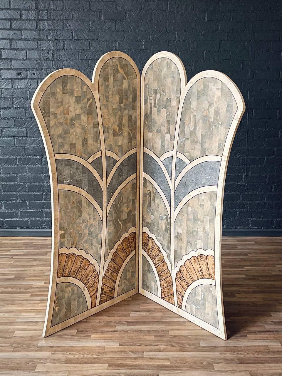 Esempio di artigianato Art Déco, questo paravento pieghevole in pietra intarsiata vanta intricati motivi a tasselli e dettagli in ottone. I suoi eleganti motivi a ventaglio e le sue curve scultoree creano una dichiarazione visiva di grande impatto,