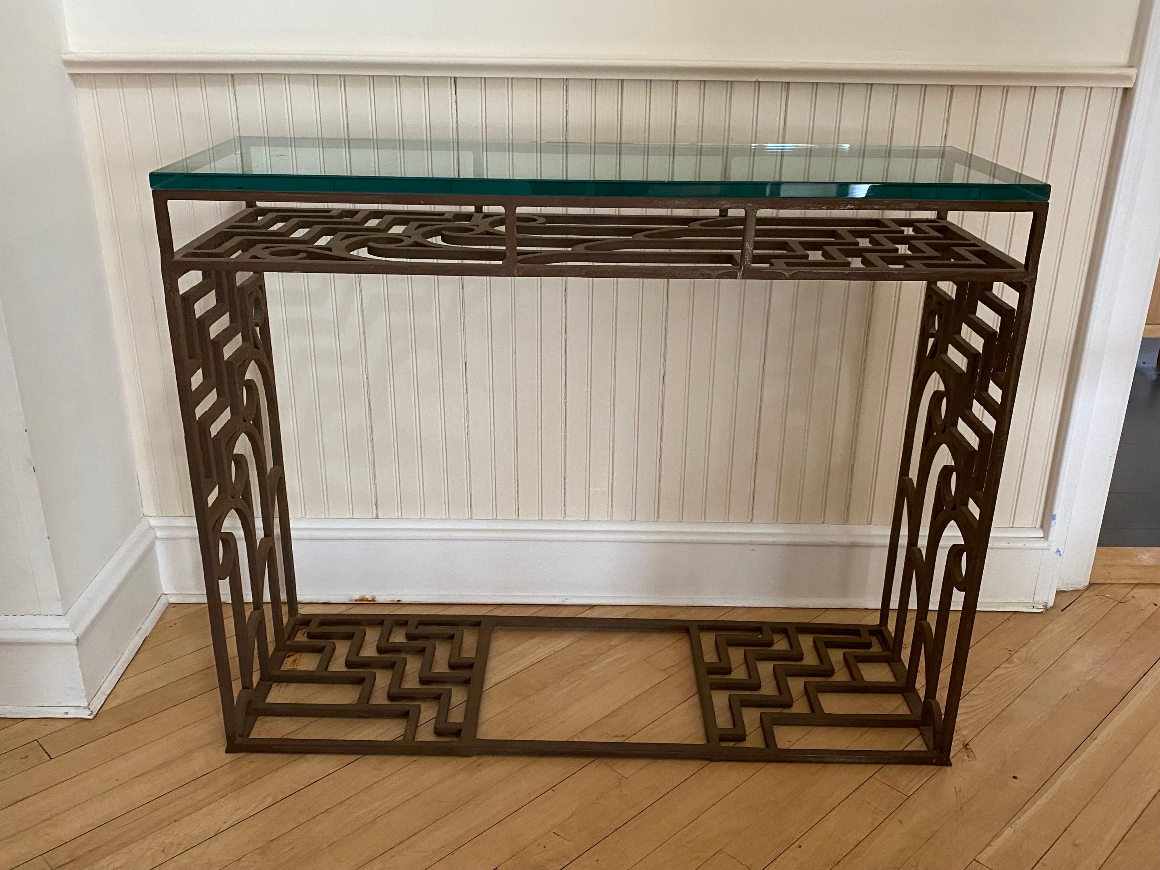 Art Deco style iron & glass console table, 20th century.
Iron base with wonderful Art Deco pattern. A shelf just below the glass. Thick 5/8