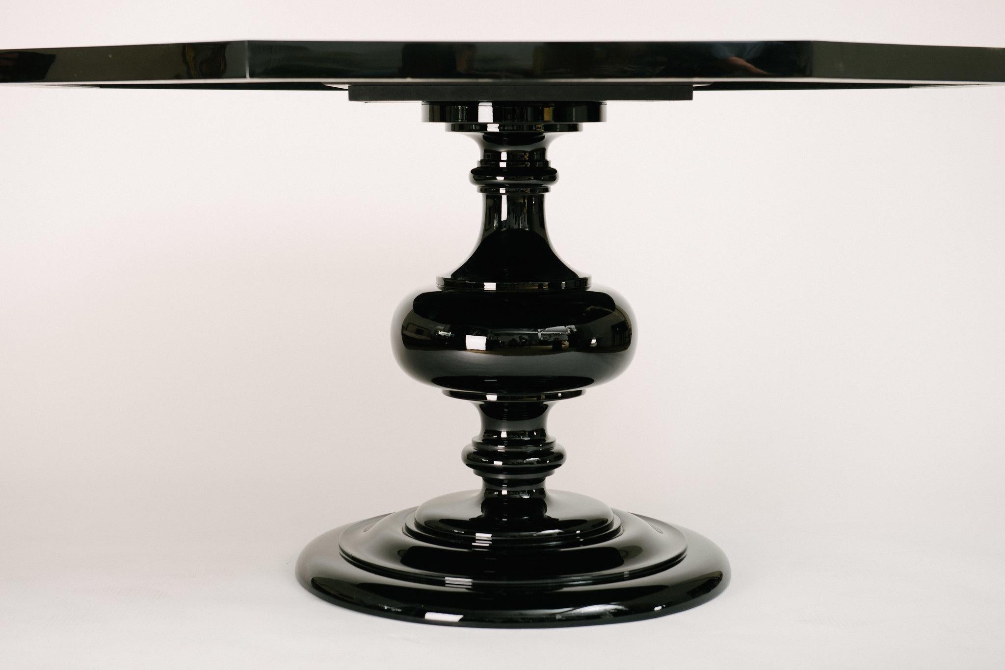 Highly stylized Italian lacquered octagon table top with faux tortoise and faux ivory detailing all atop an ebonized pedestal base.