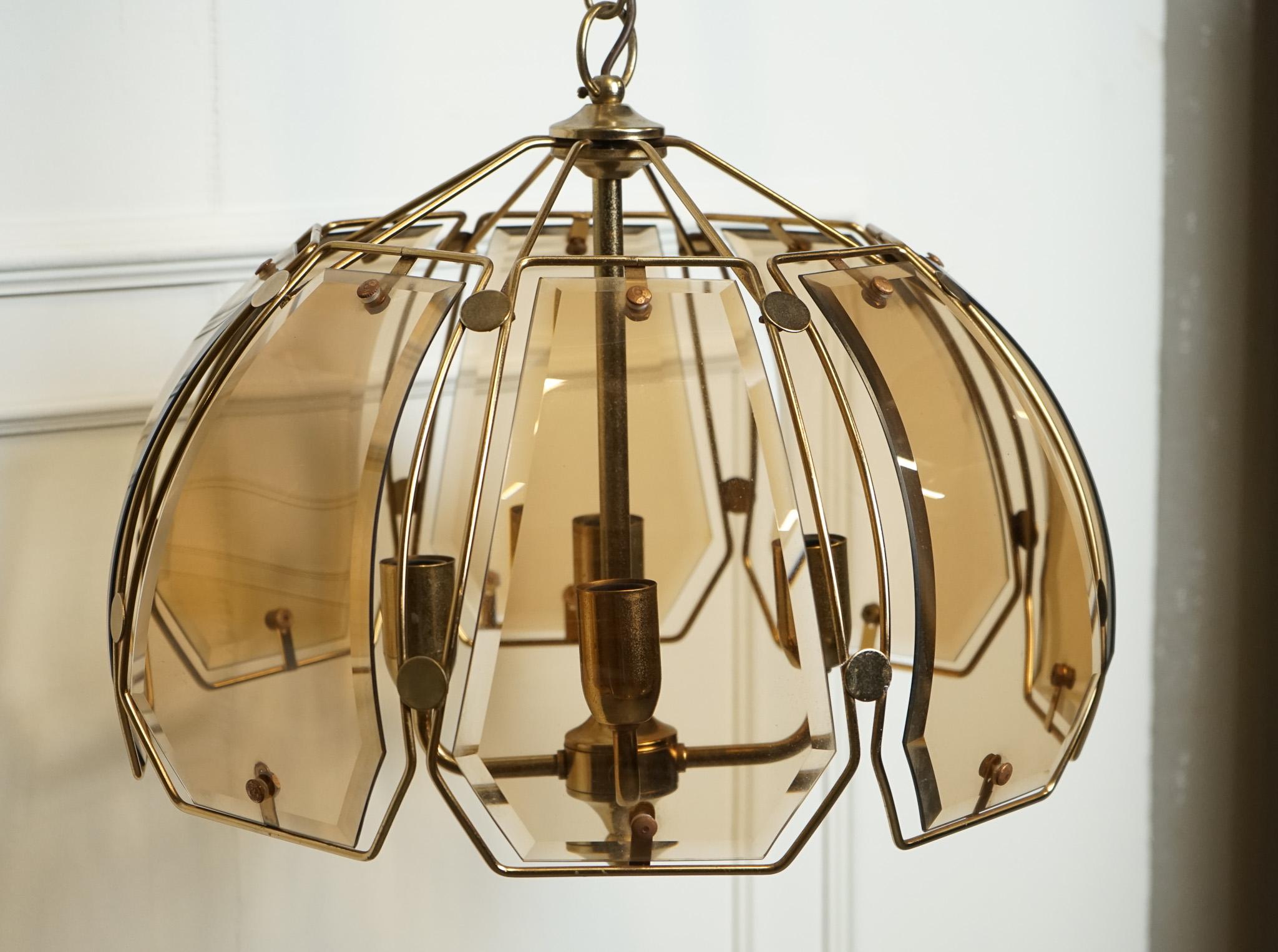 

We are delighted to offer for sale this Art Deco Style Italian Smoked Bevelled Glass Chandelier.

An Art Deco style Italian chandelier features a striking design with smoked bevelled glass elements that give it a luxurious and elegant aesthetic.