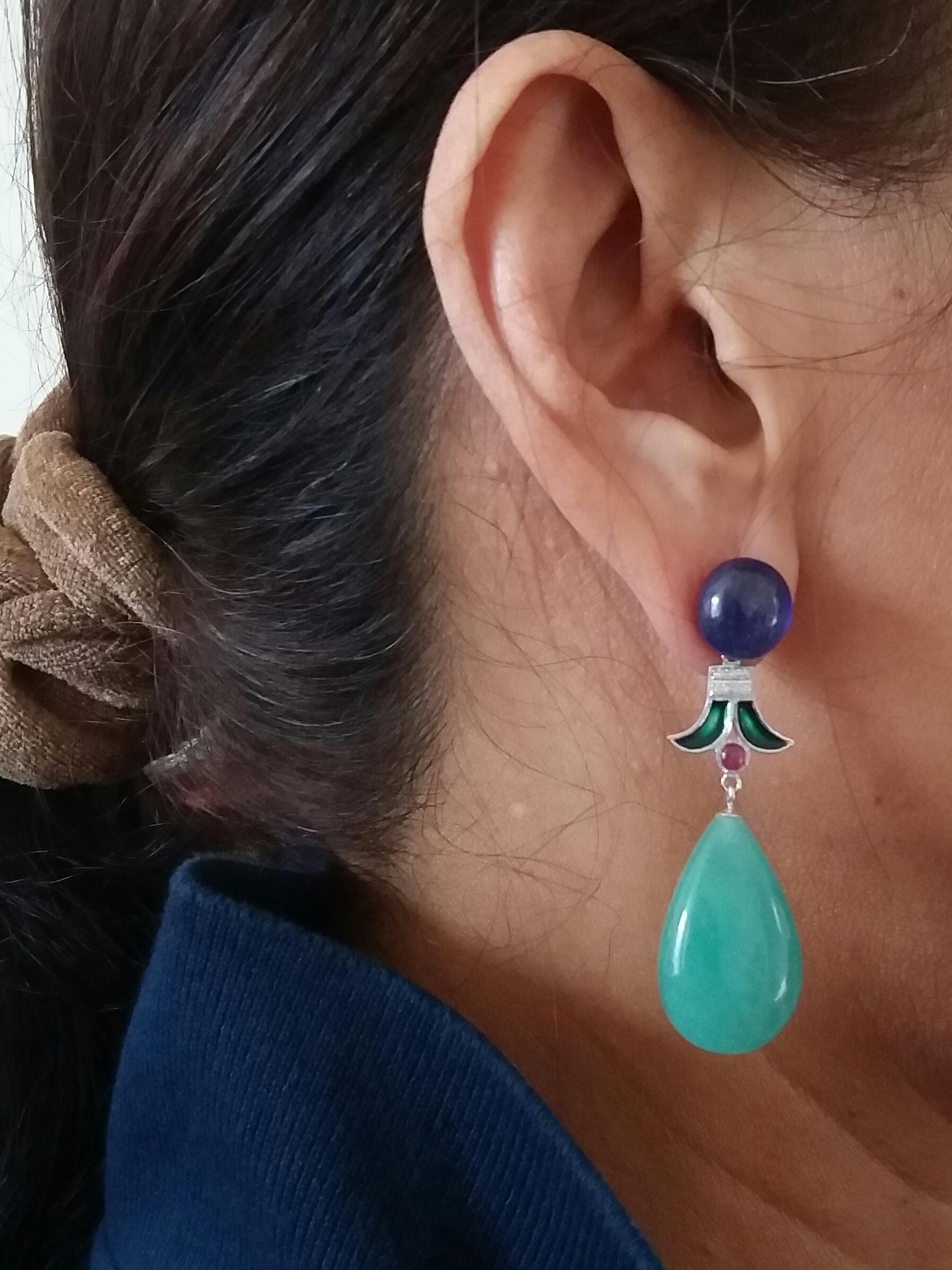 in the upper part we have 2 large oval cabochons in Blue Sapphire, the central part is composed of 2 elements in gold diamonds rubies and green enamel, the lower part is made up of 2 large plain drops of Jade
In 1978 our workshop started in Italy to