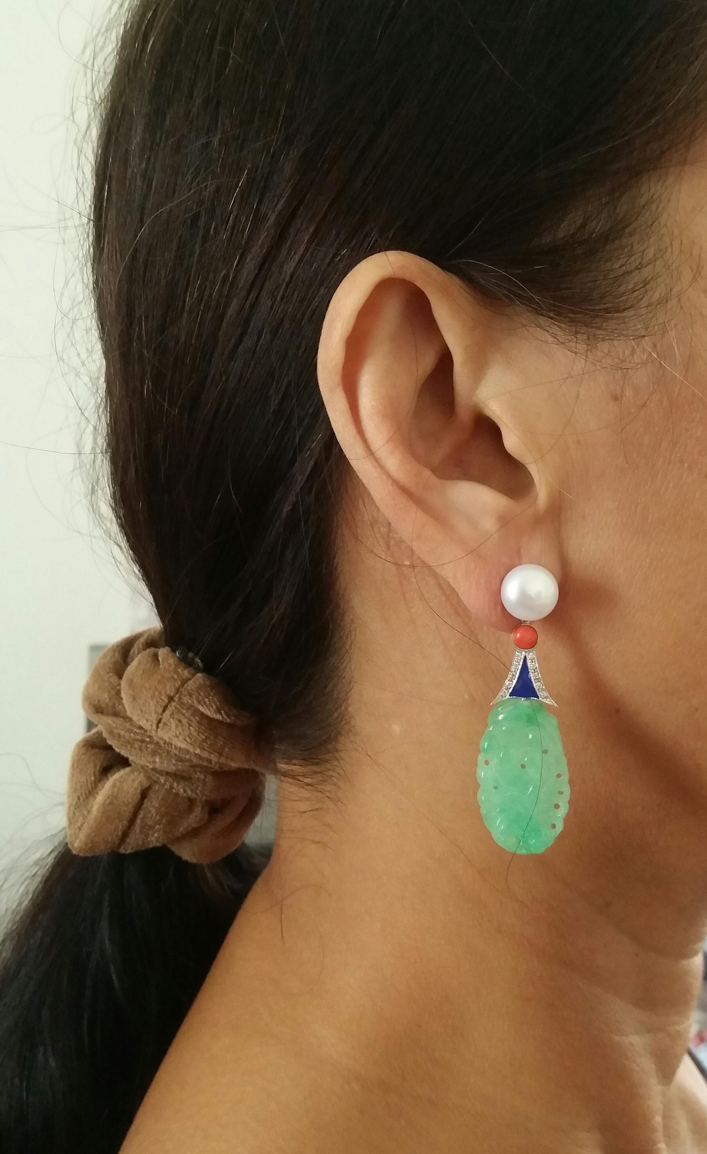 these earrings have 2 pearls of 10 mm in diameter that support 2 elements in white gold diamonds blue enamel  with 2 small round coral cabochons, in the lower part we find 2 engraved  oval shape jades
In 1978 our workshop started in Italy to make