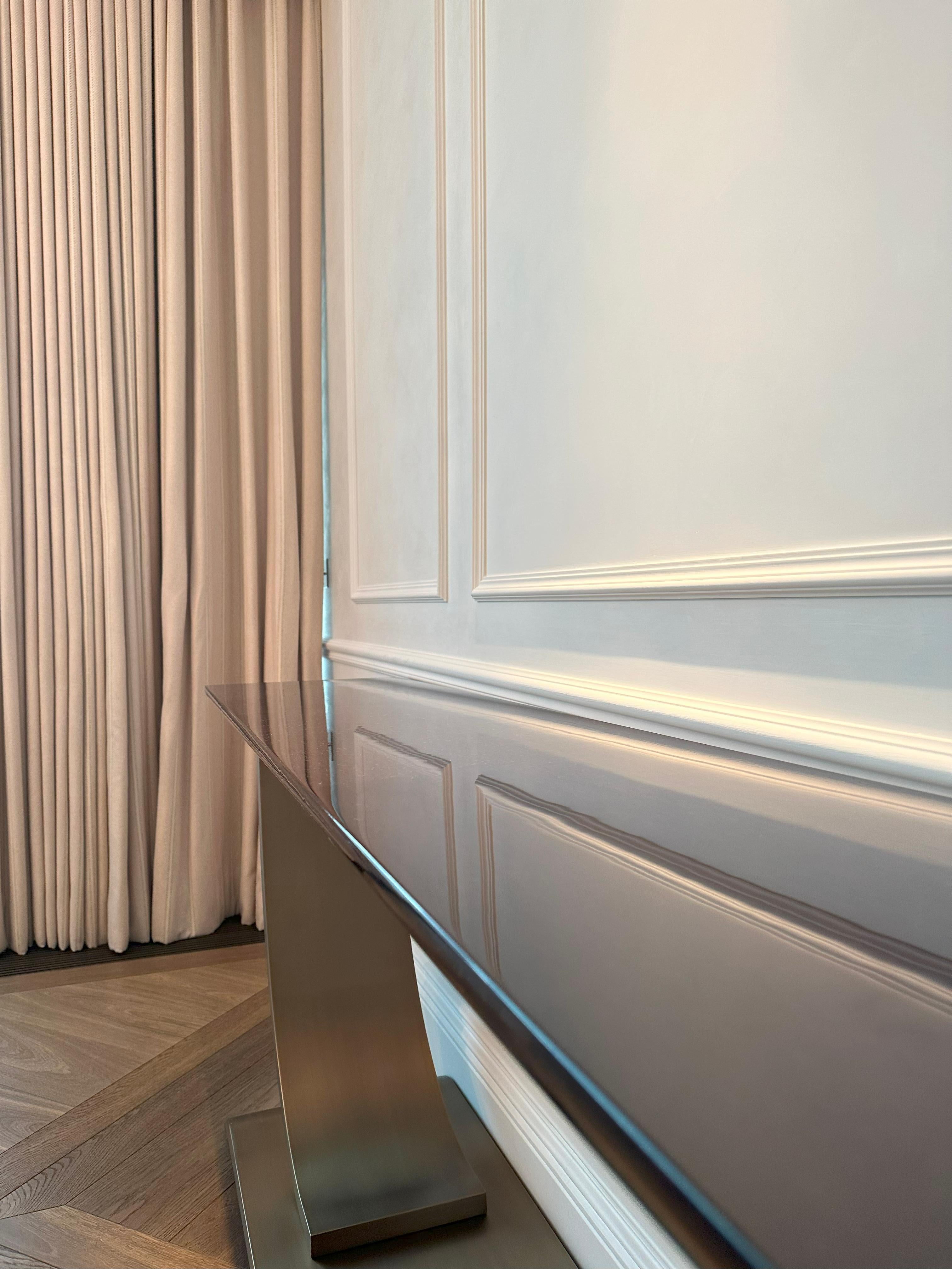 Created by French furniture house Hugues Chevalier, this console table offers a modern interpretation of Art Deco style.

Named Haussmann, the design is defined by its strong lines and balanced proportions. The top is crafted from oak, stained in a