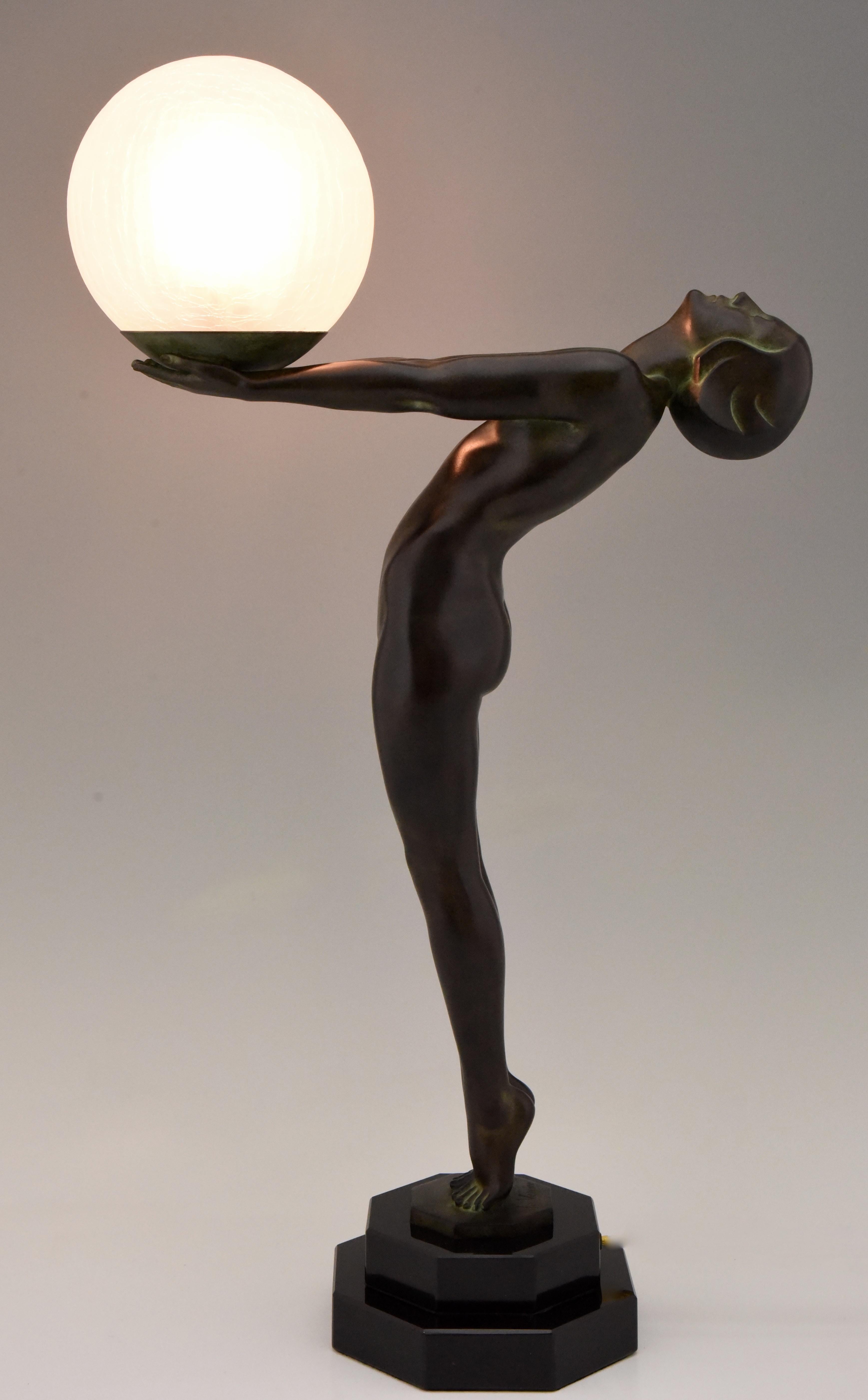 Impressive Art Deco figural table lamp of a standing nude holding a glass shade, CLarté, Lumina.
Measures: H. 65 cm or 25.6 inch tall.
Designed by Max Le Verrier in France, 1928.
Original posthumous contemporary cast at the Le Verrier foundry.