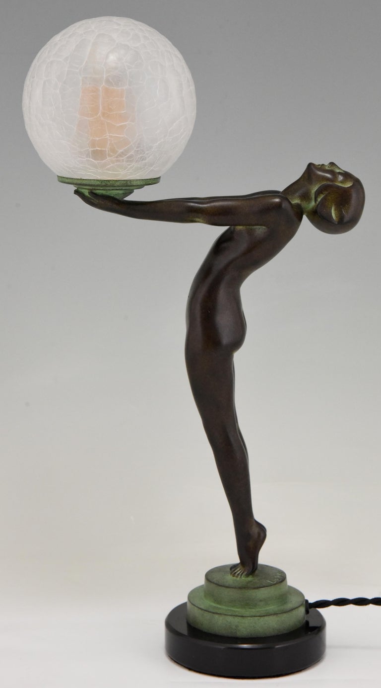 Art Deco style figural table lamp of a standing nude lady holding a glass globe.
This model is called Lueur lumineuse and is the smaller version of the iconic Clarté lamp by Max Le Verrier.
The lamp is signed and has the Le Verrier foundry mark.