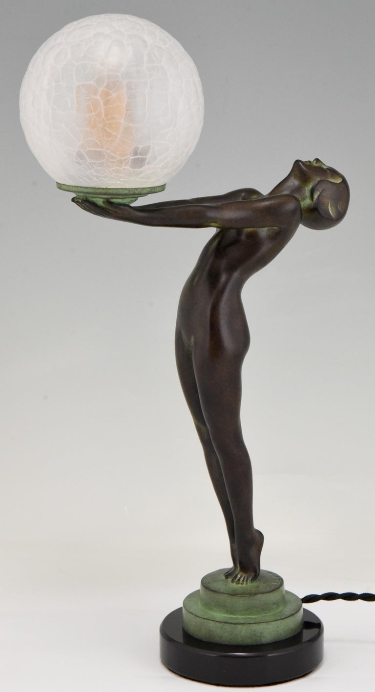 Patinated Art Deco Style Lamp Clarté Standing Nude Holding a Glass Shade Max Le Verrier  For Sale