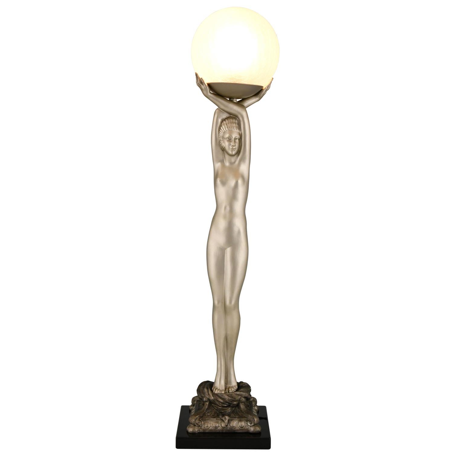 Art Deco style lamp standing nude with globe after a model by Pierre Le Faguays. Art Metal with silver patina, black marble base and glass globe. France, production period ca. 60s /70s

Literature:
“Art Deco sculpture” by Victor Arwas, Academy.