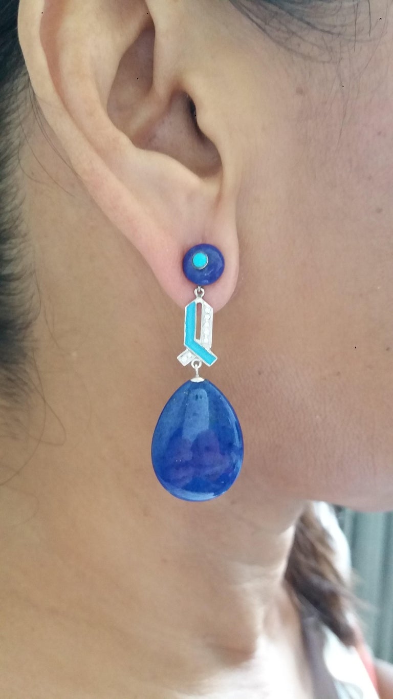 2 lapislazuli buttons tops with small turquoise round cabochon  in the center,middle parts in white gold, 14 round full cut diamonds,light blue color enamel, 2 Lapislazuli flat plain drops
Length 50 mm
Width 18 mm
Weight 11 grams
In 1978 our