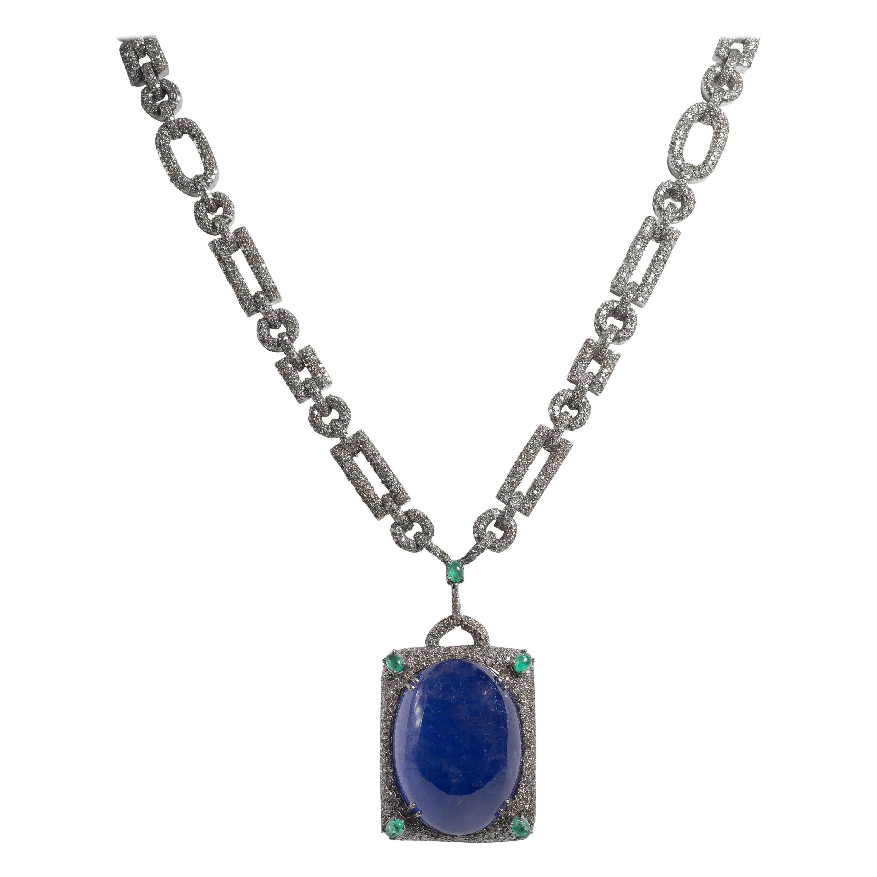 Art Deco Style Large 105 Carat Cabochon Tanzanite Diamond Emerald Long Necklace 
Wonderful 28 inch long necklace sautoir comprising a 105 carat Tanzanite cabochon set with 17.89carats soft grey diamonds accented with 0.61 carats emeralds set in