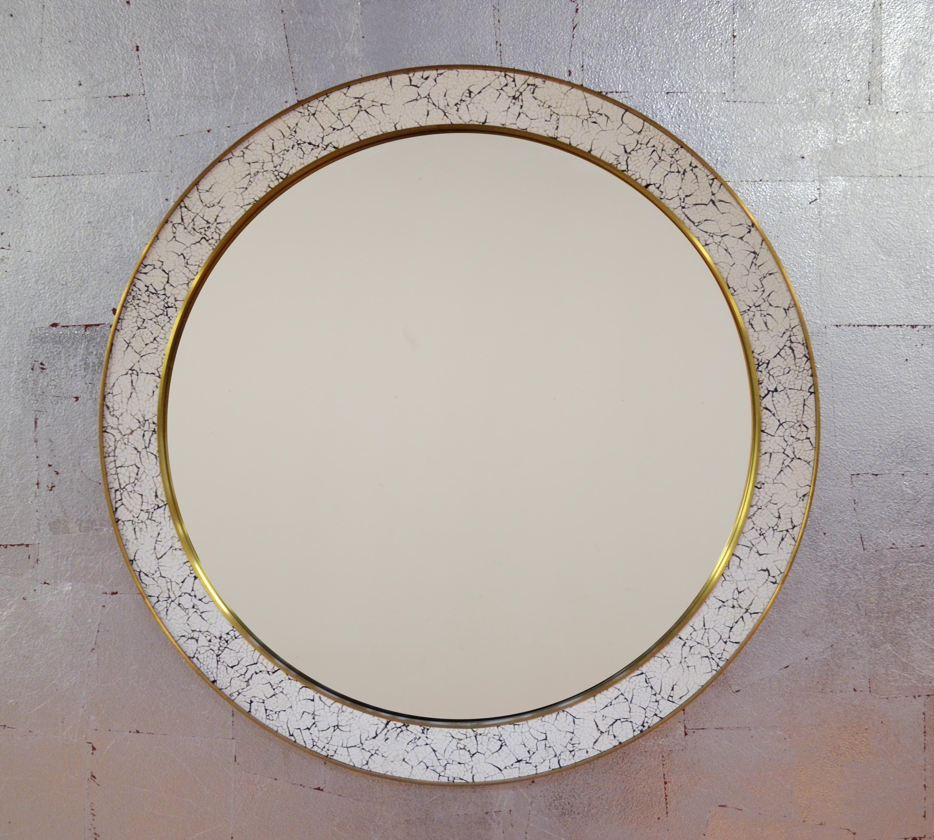 Hand-cracked eggshell and lacquer frame, trimmed in brass or antique bronze. Eglomisé mirror available.
Dimensions: 48