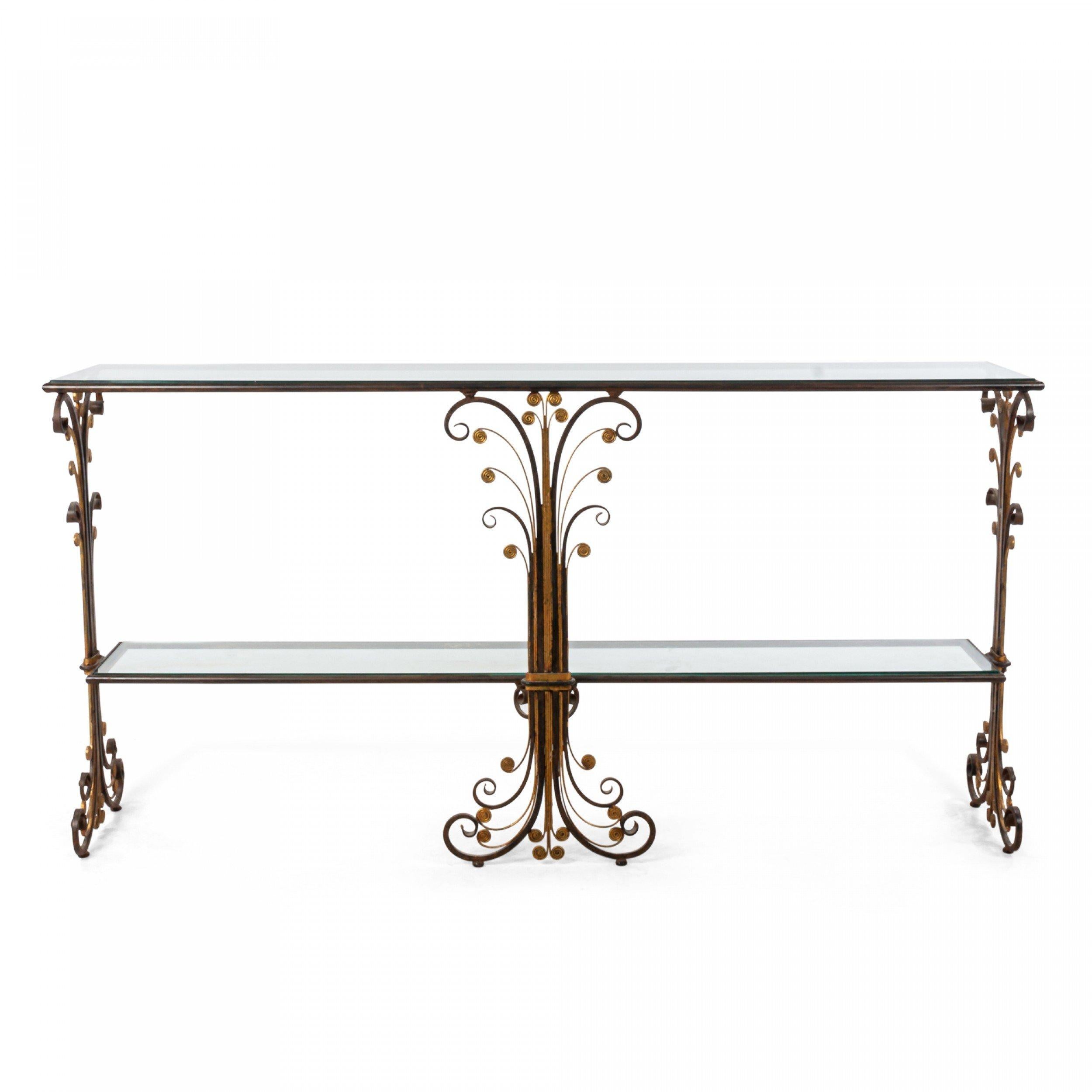 French Art Deco style two-tier iron console (Davenport) table with gilt trim and scroll design sides and center support with an inset glass top and shelf.