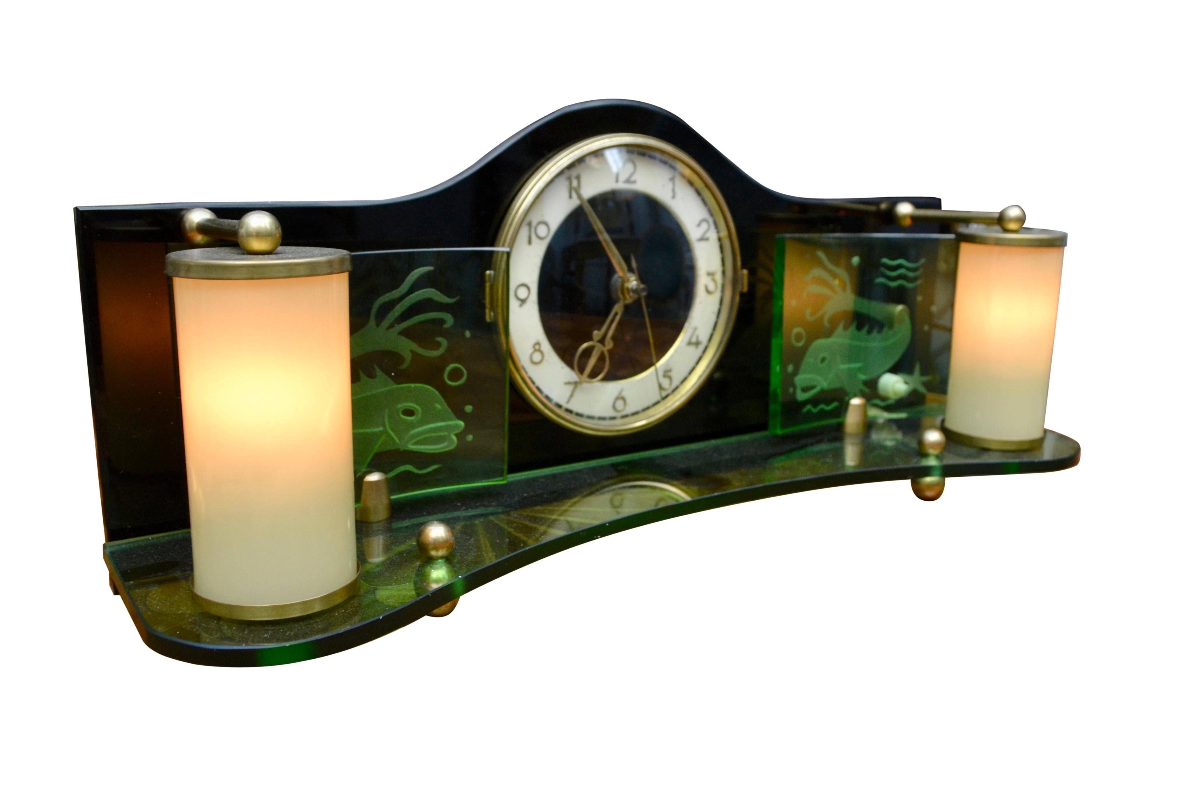 Beautiful Art Deco style mid century clock -made in the 50's by the famous German maker Palmtag factory. 

The clock movement and dial are set in the middle of a stylized sheet of black glass. This vertical clock glass is set on a curved sheet of