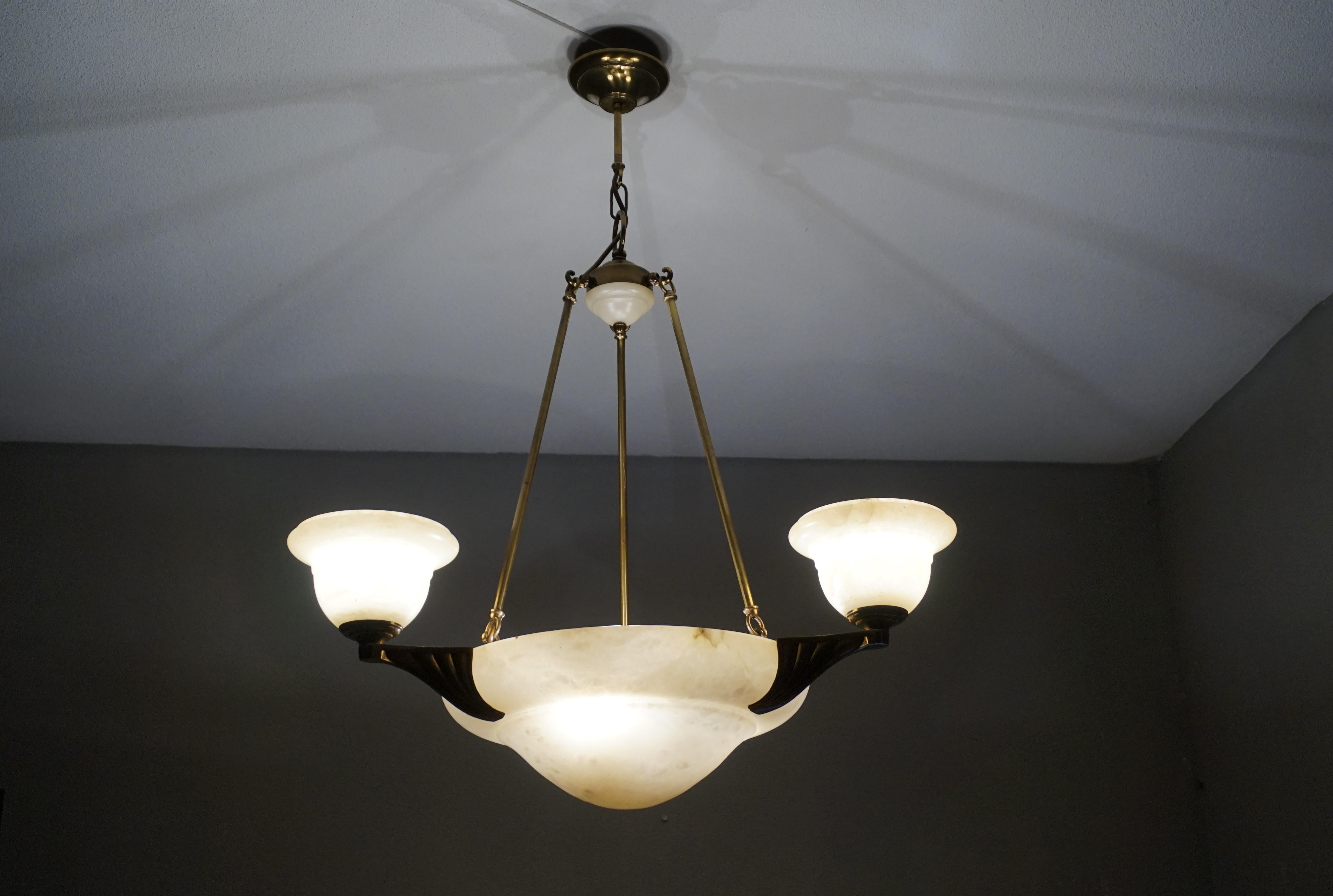 Excellent condition and rare design, 6-light chandelier.

If you like Arts and Crafts light fixtures, but you prefer to have them shiny like new, then this 1970s alabaster and bronze chandelier could be perfect for you. The combination of the creamy