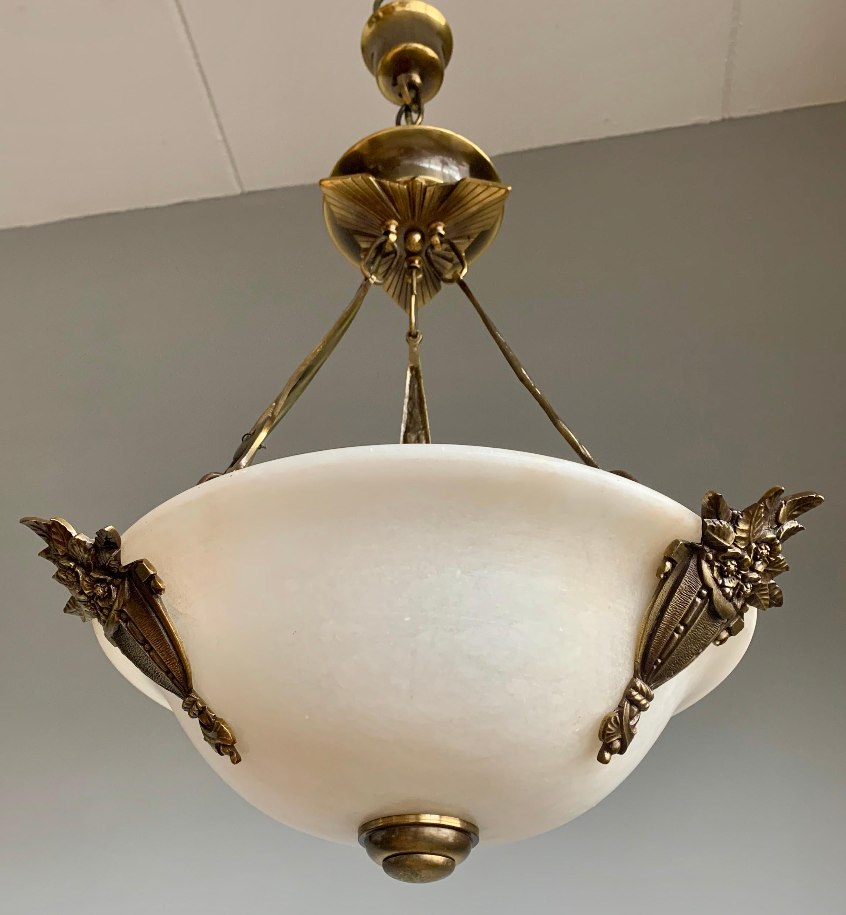 Excellent condition and rare design, 3-light chandelier.

If you like Art Deco light fixtures, but you prefer to have them like new, then this 1970s alabaster, bronze and brass chandelier could be perfect for you. The combination of the white