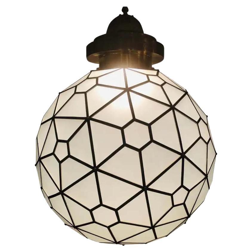 Light up your room with this stunning Art Deco style globe round milk glass white chandelier or lantern with brass inlay. Finely hand crafted, the pendant features a beautiful filigree design canopy. Recently wired setting housing two bulbs.
These