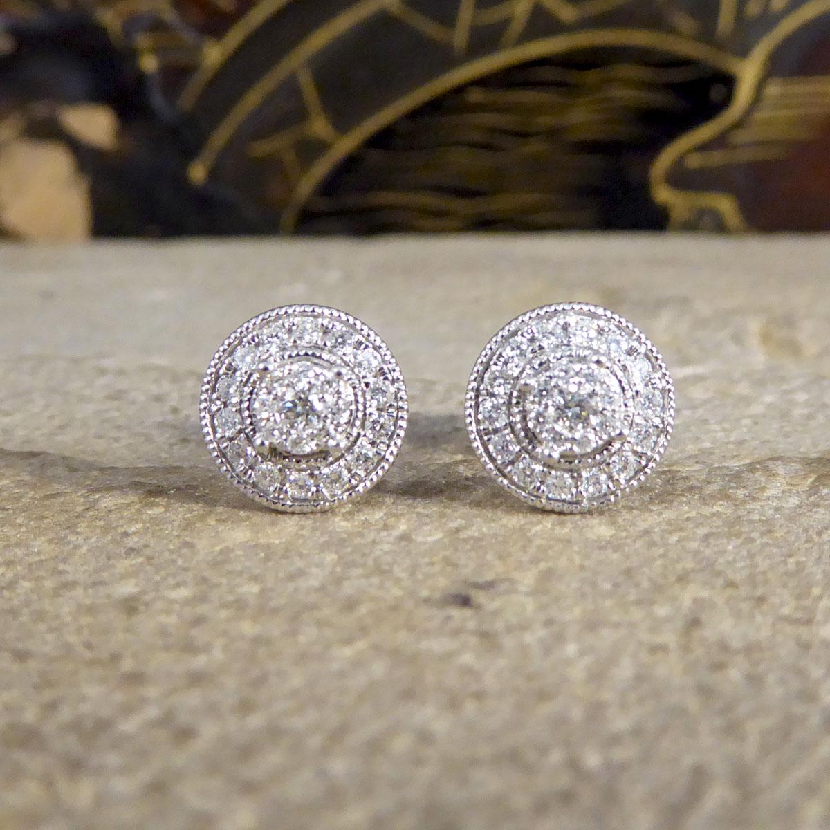 These beautiful contemporary earrings have been made with so much detail in an Art Deco style. Using such a lovely design, the Diamonds have been set in a cluster form with a Diamond halo surround in a milgrain setting with a total of 28pt in 46