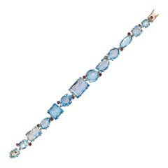 Modernes Gelbgoldarmband im Art-déco-Stil mit Rubin im Rundschliff und blauem Topas im Mischschliff