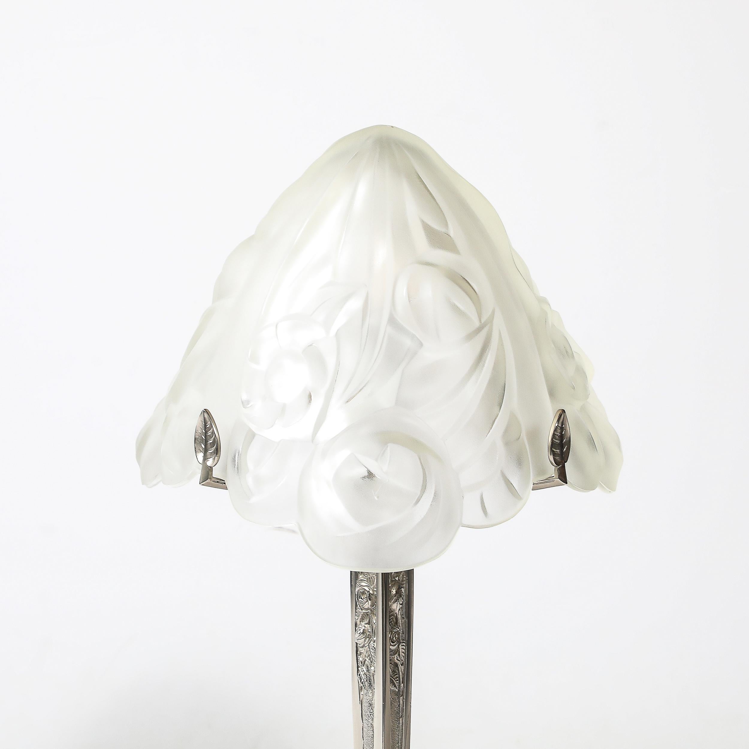 This elegant Art Deco-style table lamp from France, dating to the 20th century, exemplifies the timeless sophistication of the era. The lamp features a beautifully molded and frosted glass shade, skillfully designed with soft, diffused lighting in