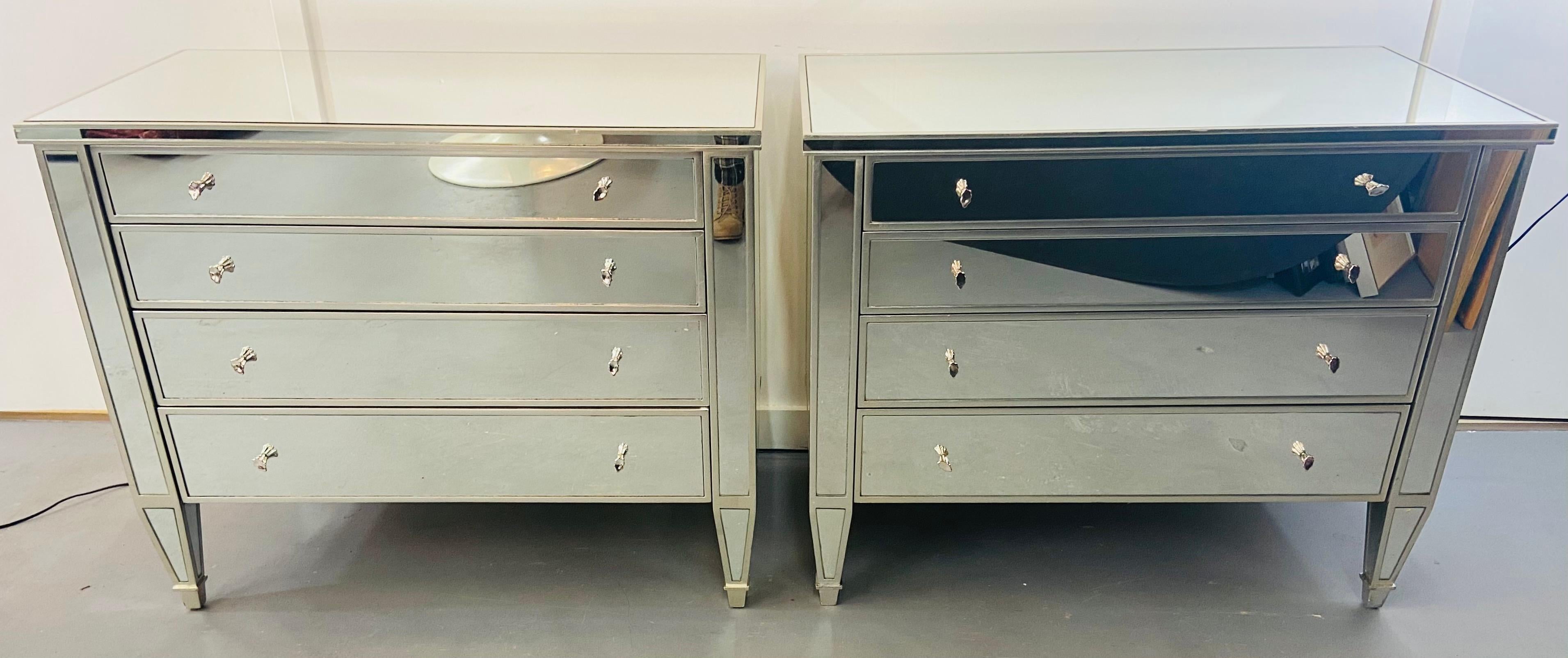 A stunning pair of Art Deco style Nancy Corzine Collette mirrored commodes, nightstands or chests. Each commode has 4 drawers with original silvered knobs and is signed inside the drawer Nancy Corzine. Classy and stylish, these pair of commodes or