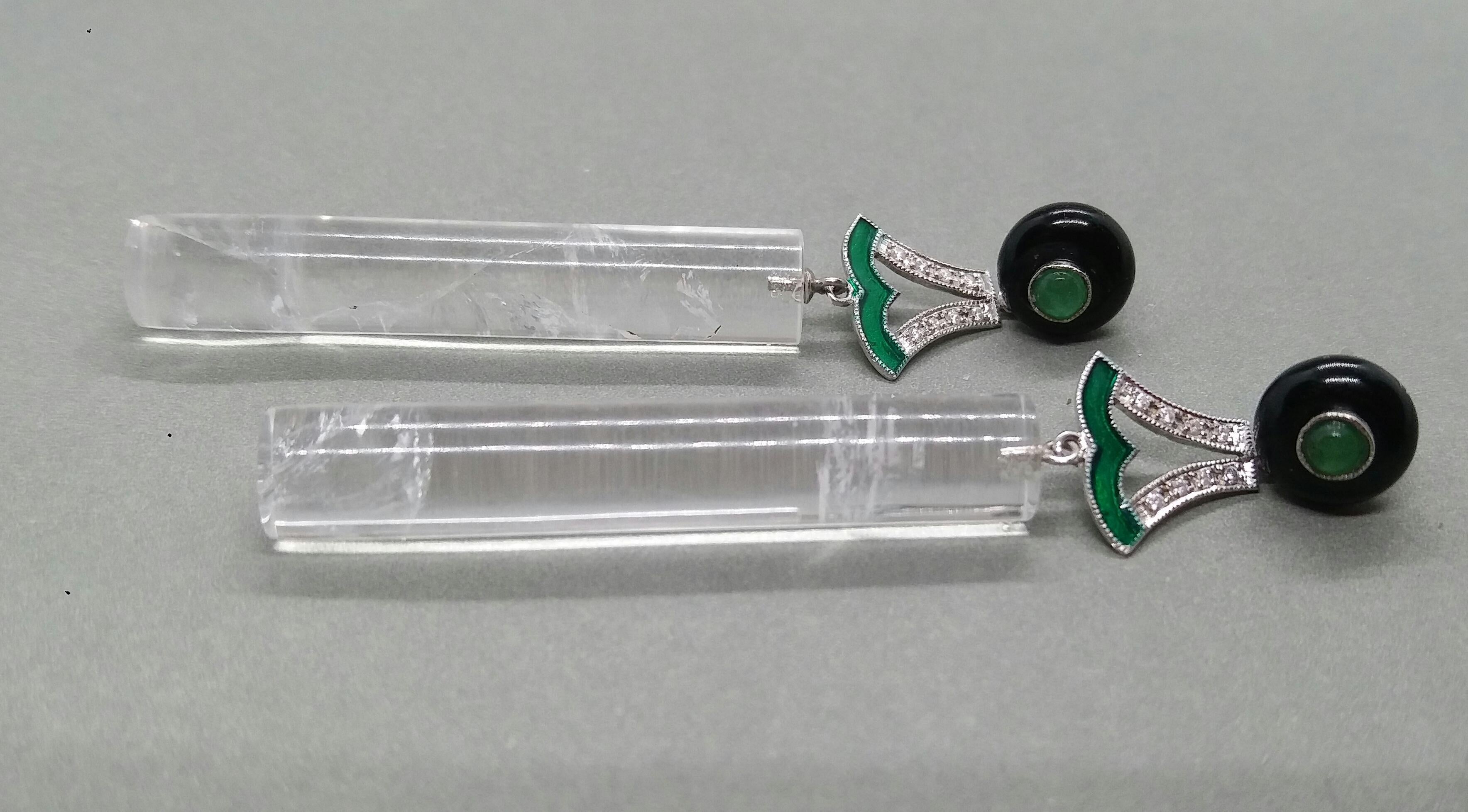 The tops are Black Onix buttons with small round emerald cabs in the center,middle  parts are composed of 2 white gold elements with 16 round full cut diamonds and green Enamel ,in the bottom parts we have 2 Natural Rock Crystal cylinders 40 mm long