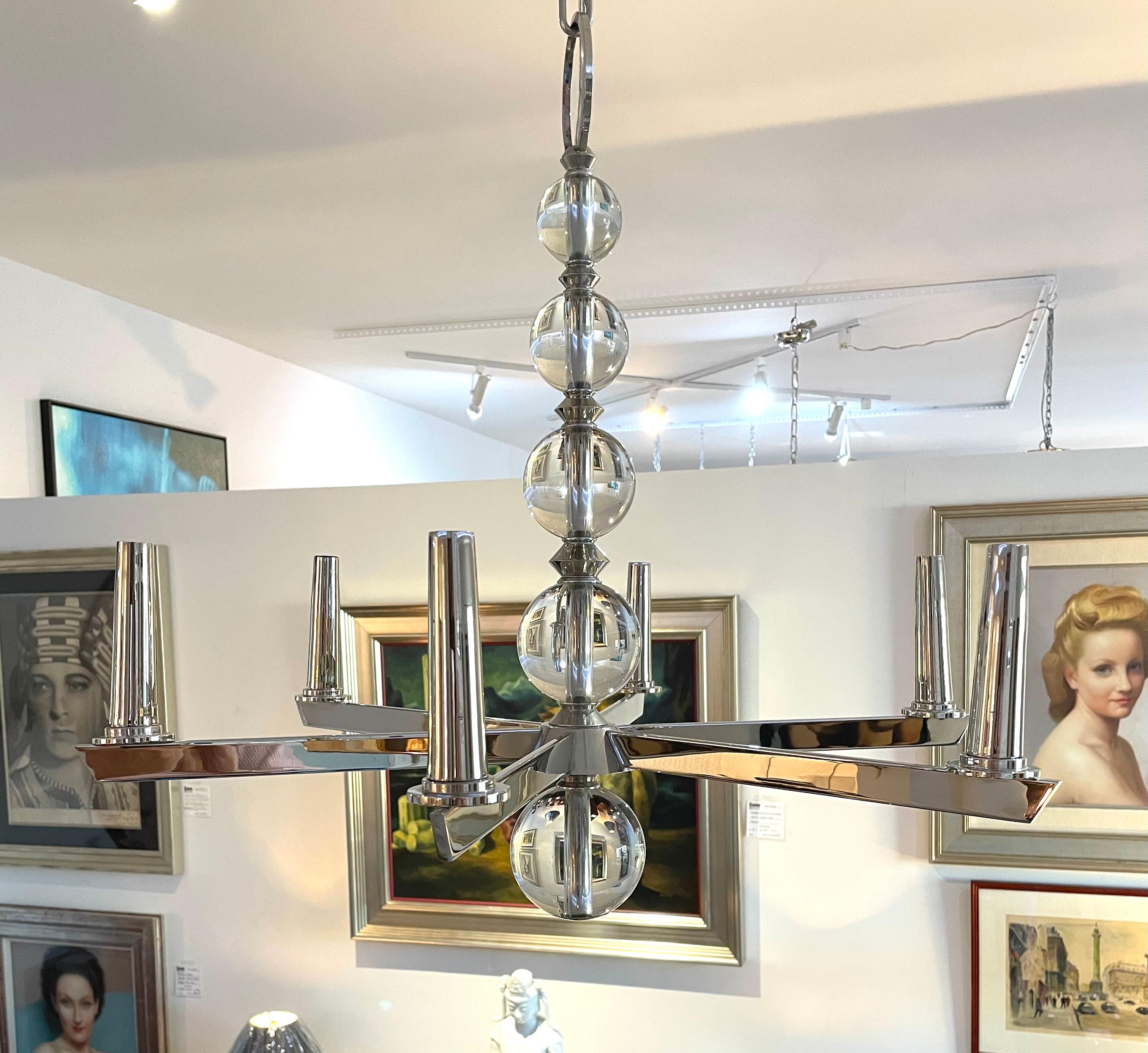 This stylish and chic Art Deco style chandelier will make a statement with its form and use of materials. The nickel plating compliments the crystal spheres beautifully. 

Note: Overall height including the chain and canopy is 49.50